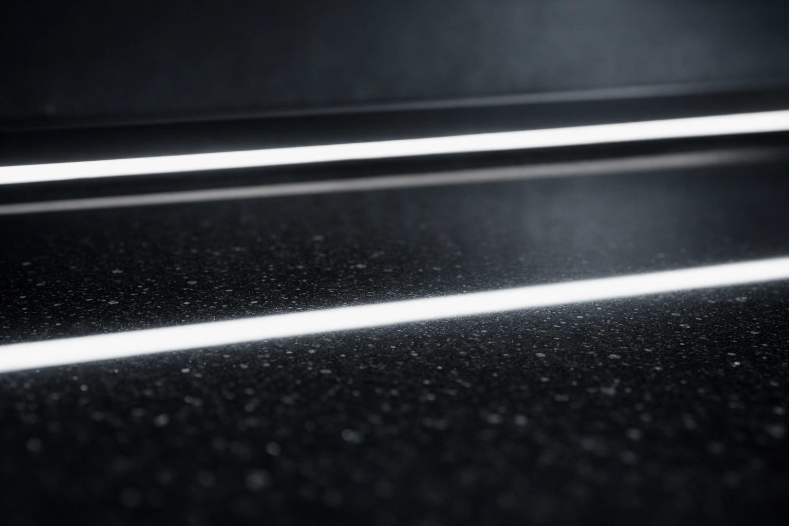 Seamless light bar reflection on black quartz from a professionally installed aluminum LED diffuser channel.