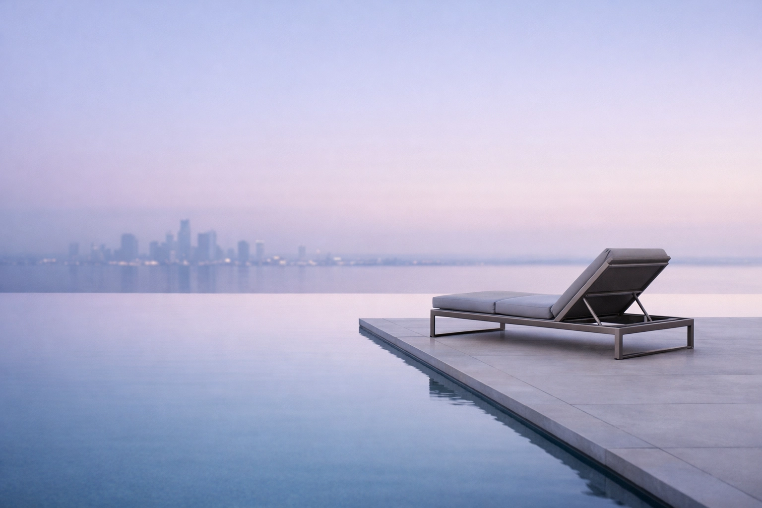 Minimalist hotel infinity pool at dusk, representing the future of hospitality technology.