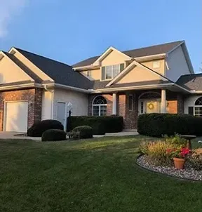 Roofer performing a targeted shingle repair on a residential home