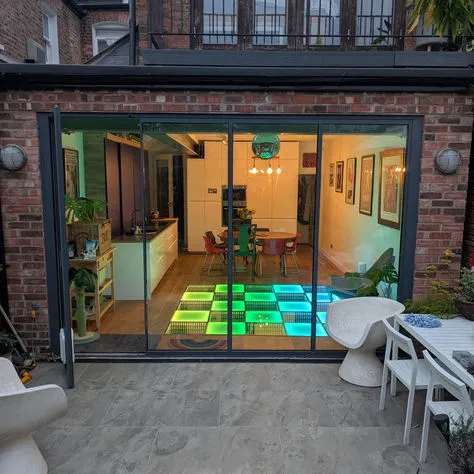Modern residential brick extension with sliding glass doors and innovative structural engineering