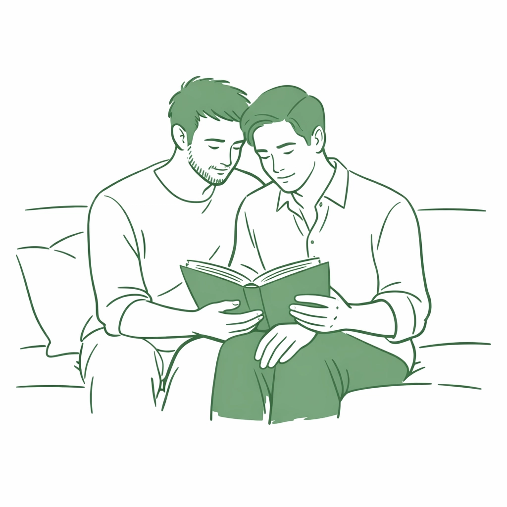 A gay couple sharing an intimate moment reading an MM romance book together on a sofa.