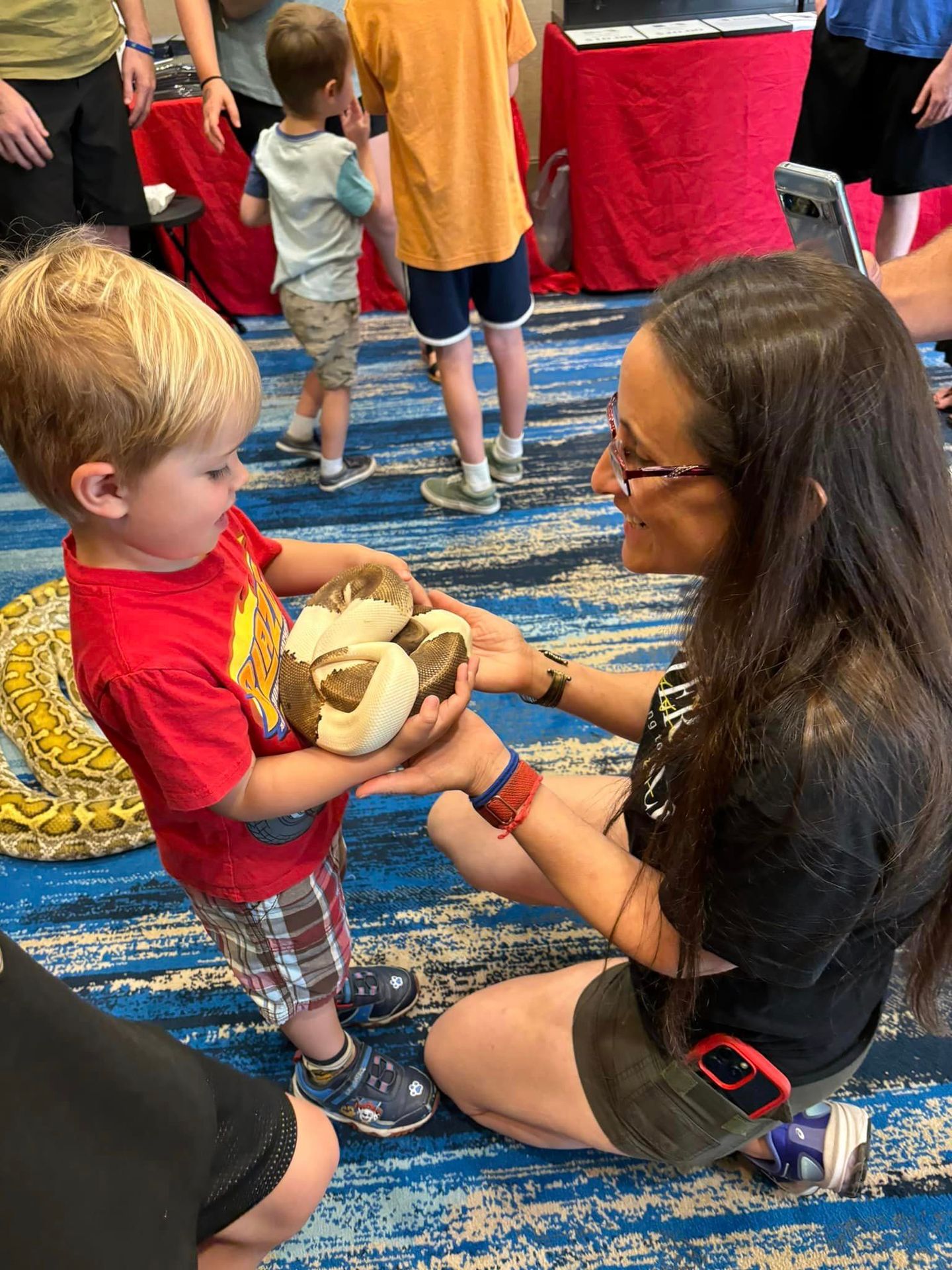 Repterience educator and children during reptile demonstration