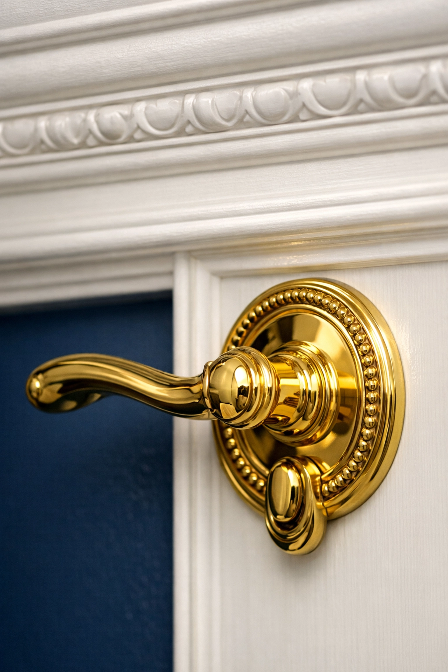 Polished brass door handle and clean crown molding after luxury house cleaning in Acton.