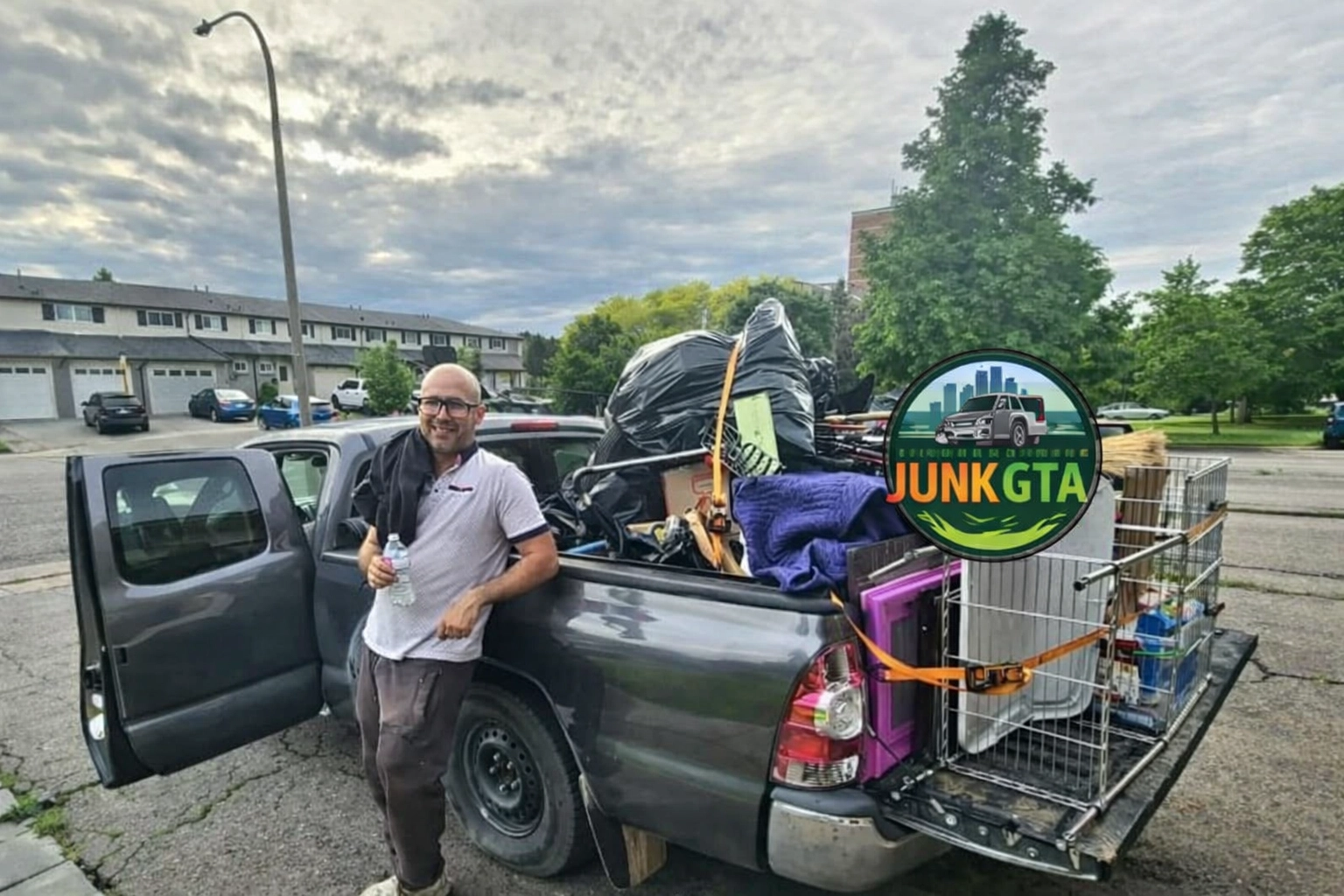 Roman, owner of Junk GTA, standing by his 2014 Toyota Tacoma