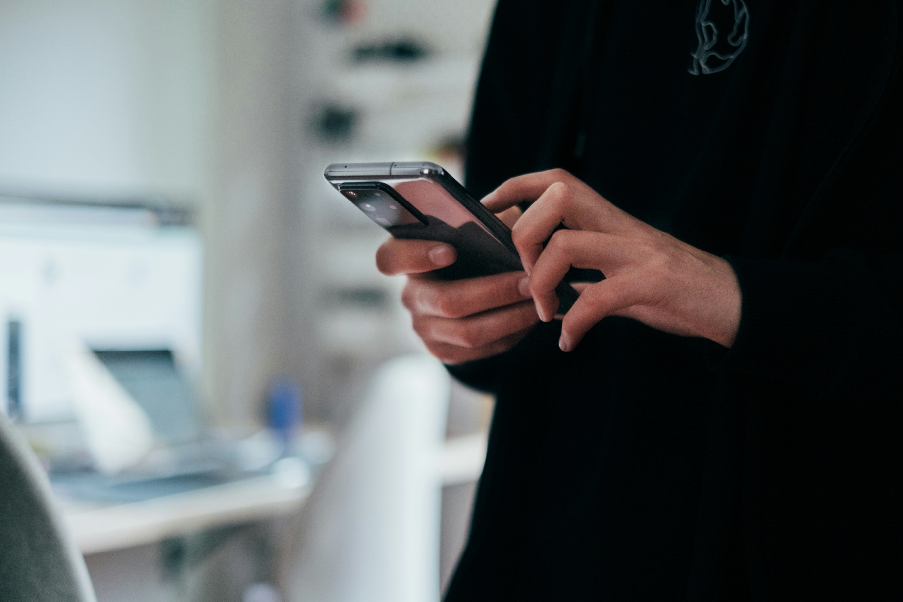 Person Using Smartphone in Office