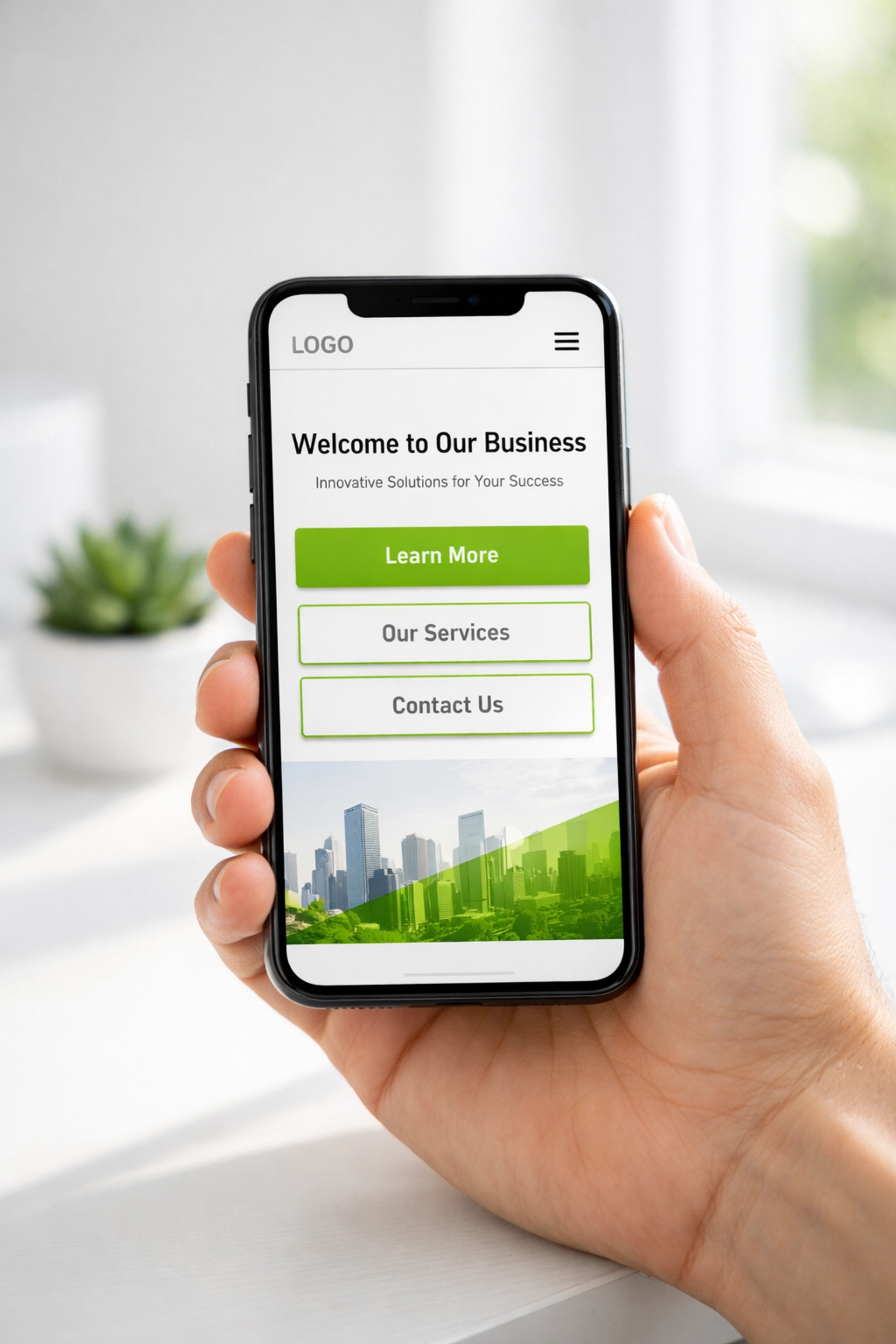 Hand holding a smartphone showing a mobile-responsive small business website design on a clean white desk.
