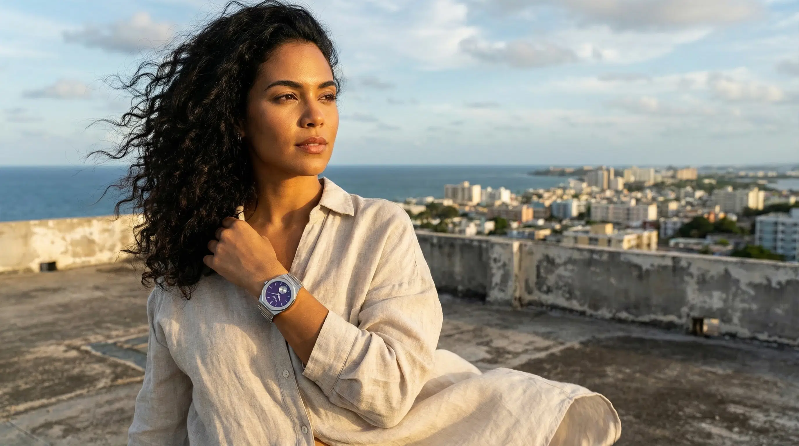 Model on rooftop with purple dial watch.