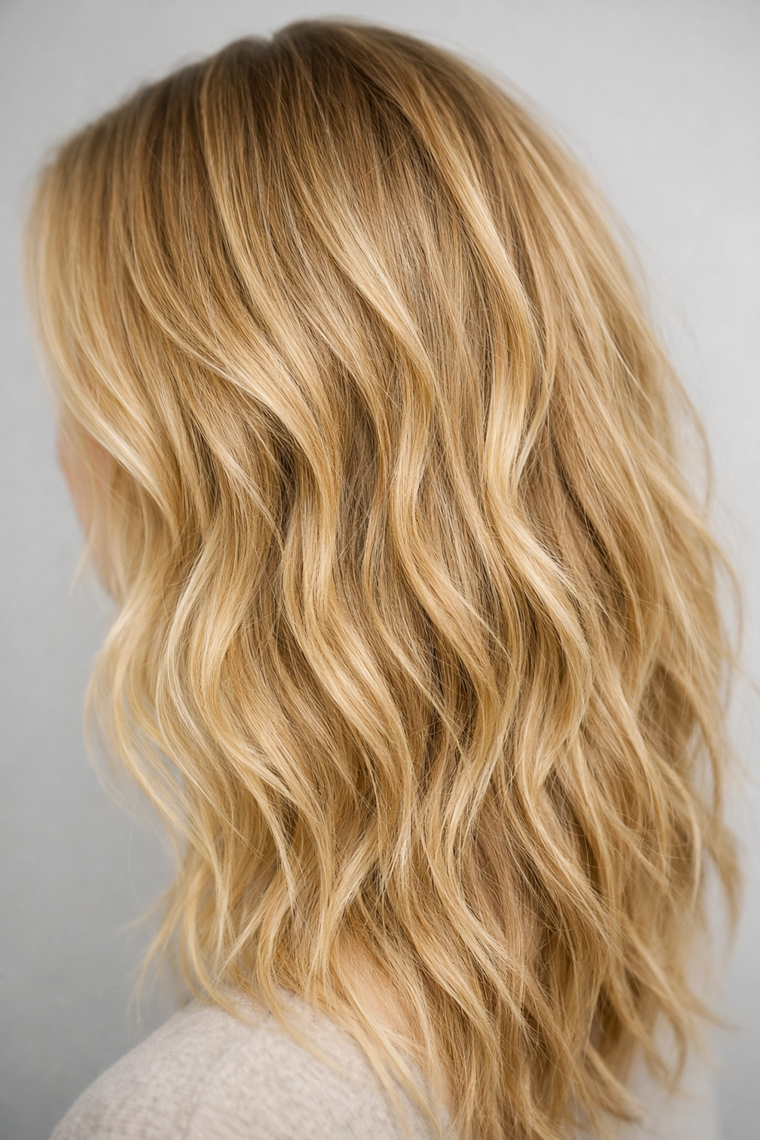 Beautiful honey blonde lived-in waves styled for summer at our professional hair salon in Concord NH.