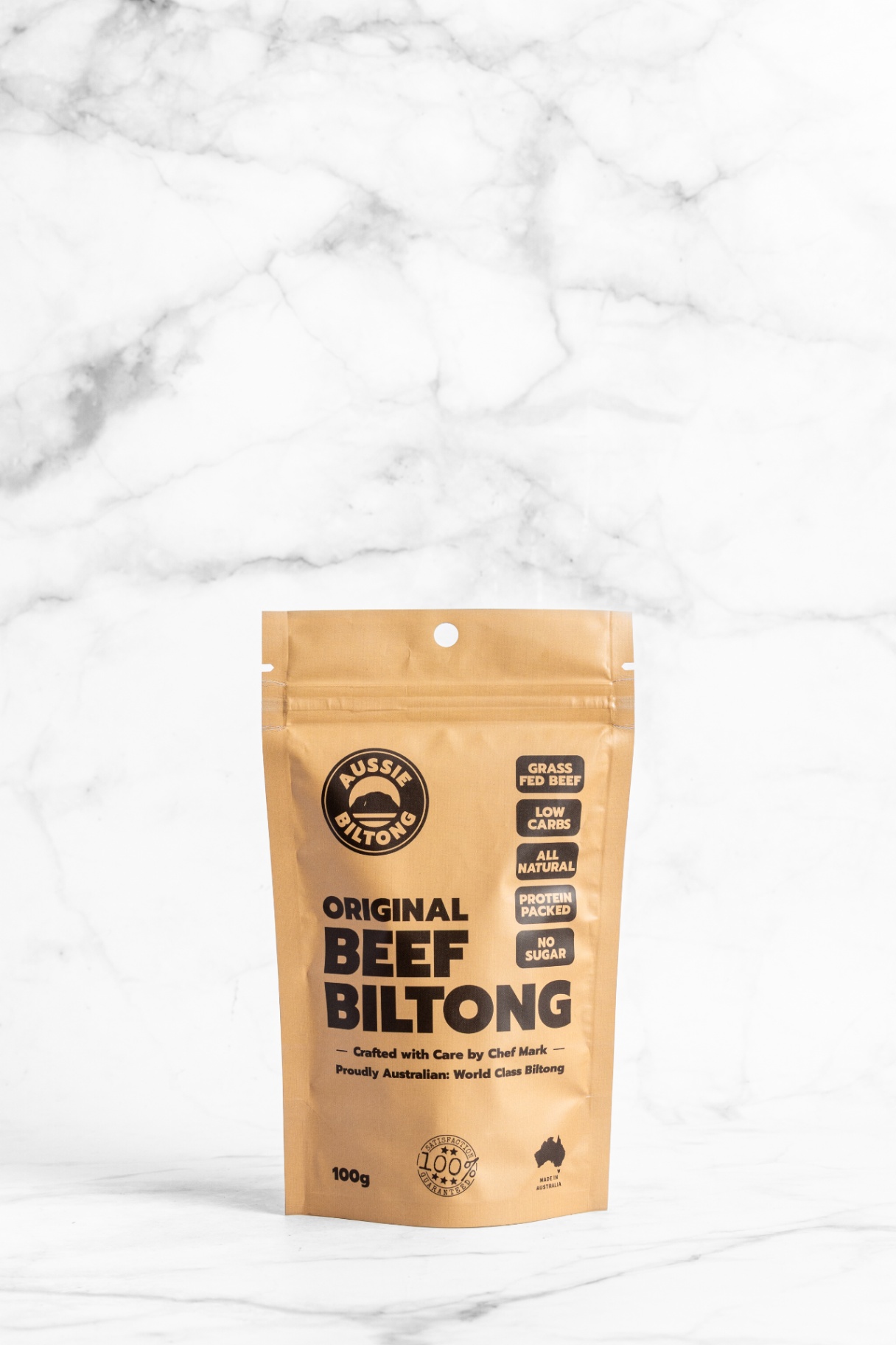 Aussie Biltong 100g pouch on marble, air dried beef, protein packed, low sugar, healthy meat snacks