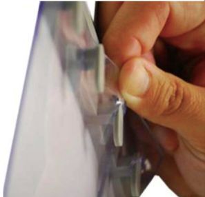 Hands fitting a PVC strip curtain onto a hook-on rail for easy DIY installation