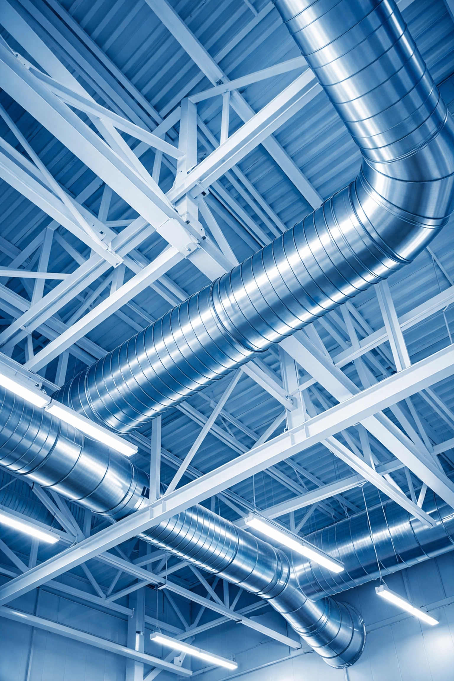 Dust-free high-level beams and clean ventilation ducts in a Stoughton industrial warehouse facility.