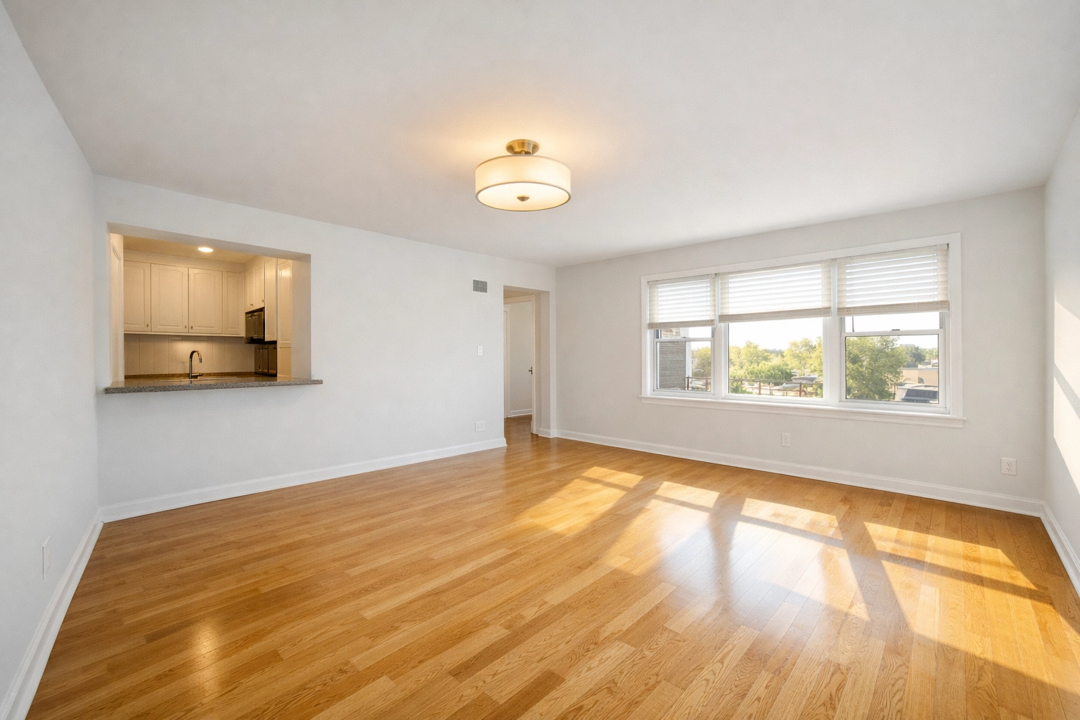 Clean, empty apartment living room with fresh paint ready for tenant showing and photography