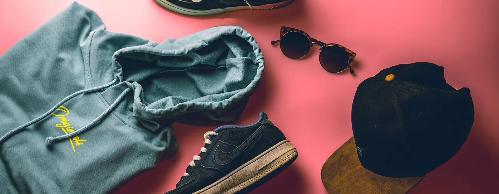 A curated vintage streetwear selection featuring a teal hoodie and Nike trainers, perfect for high-margin Depop listings.