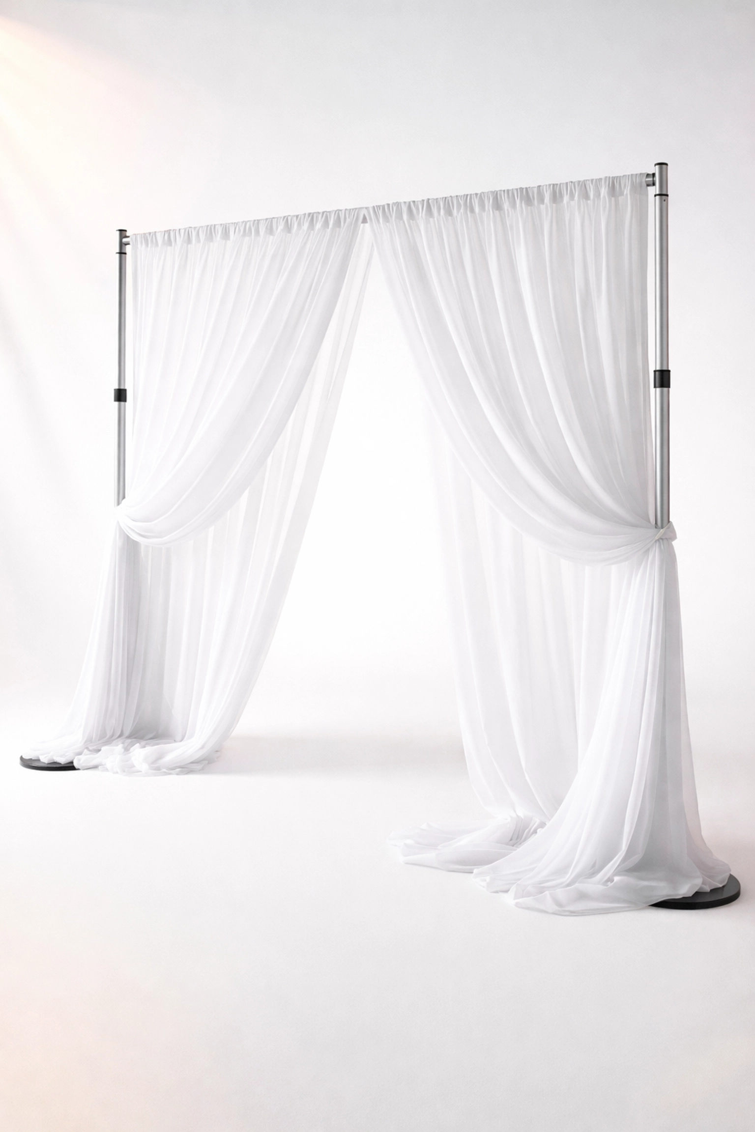 Elegant pipe and drape system with sheer white fabric panels showcasing modern event decor solutions