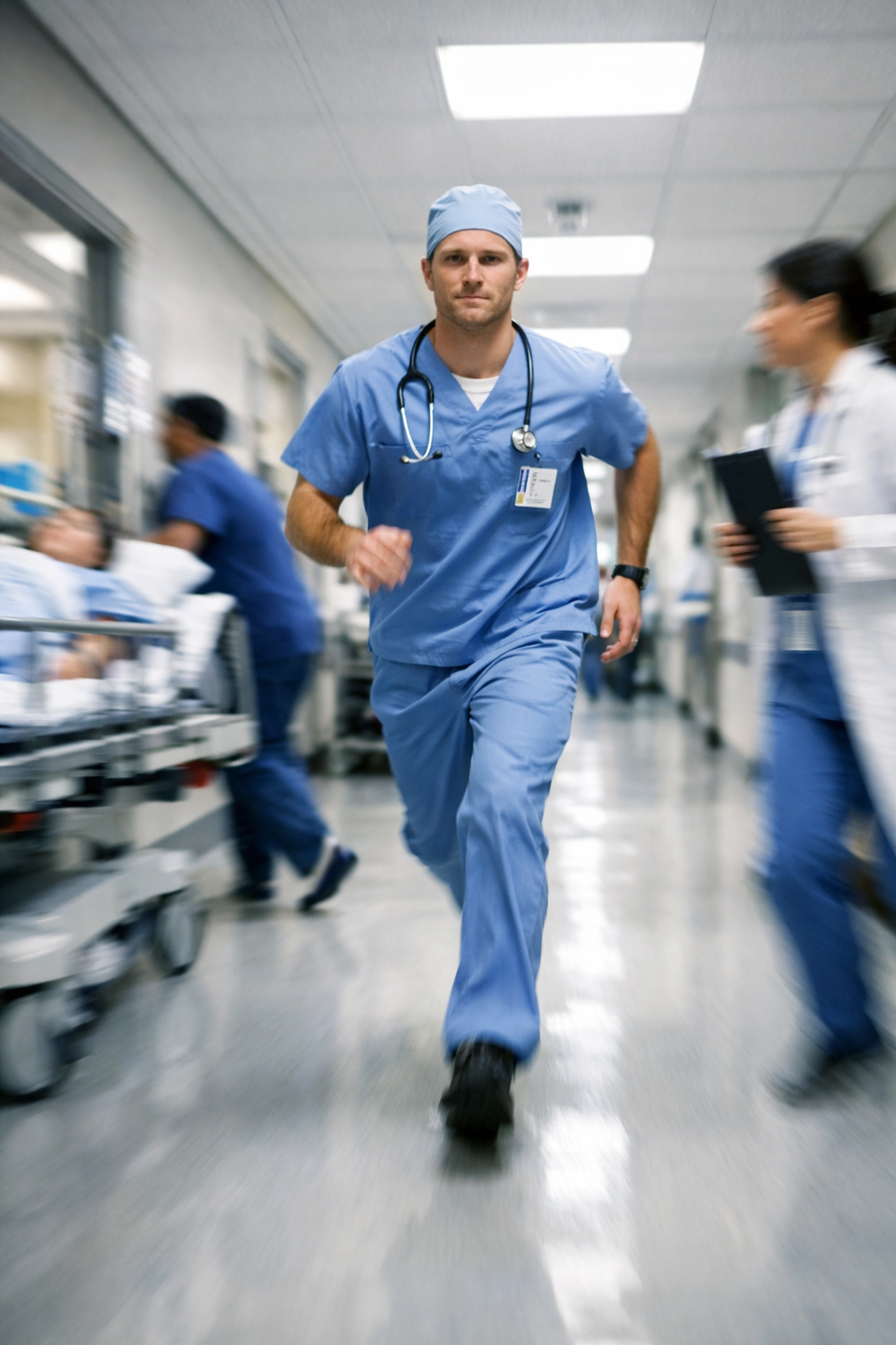 Healthcare professional in a busy hospital corridor, representing high patient throughput and physician burnout.