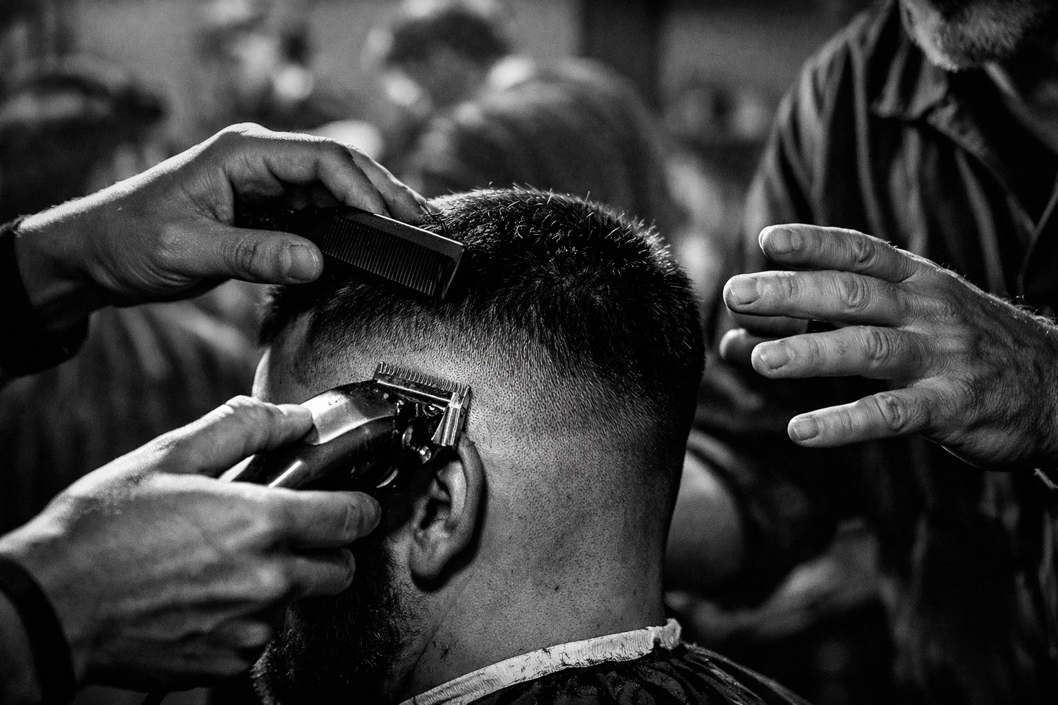Barber student performing haircut under licensed instructor supervision at X-Quisite Cutz School