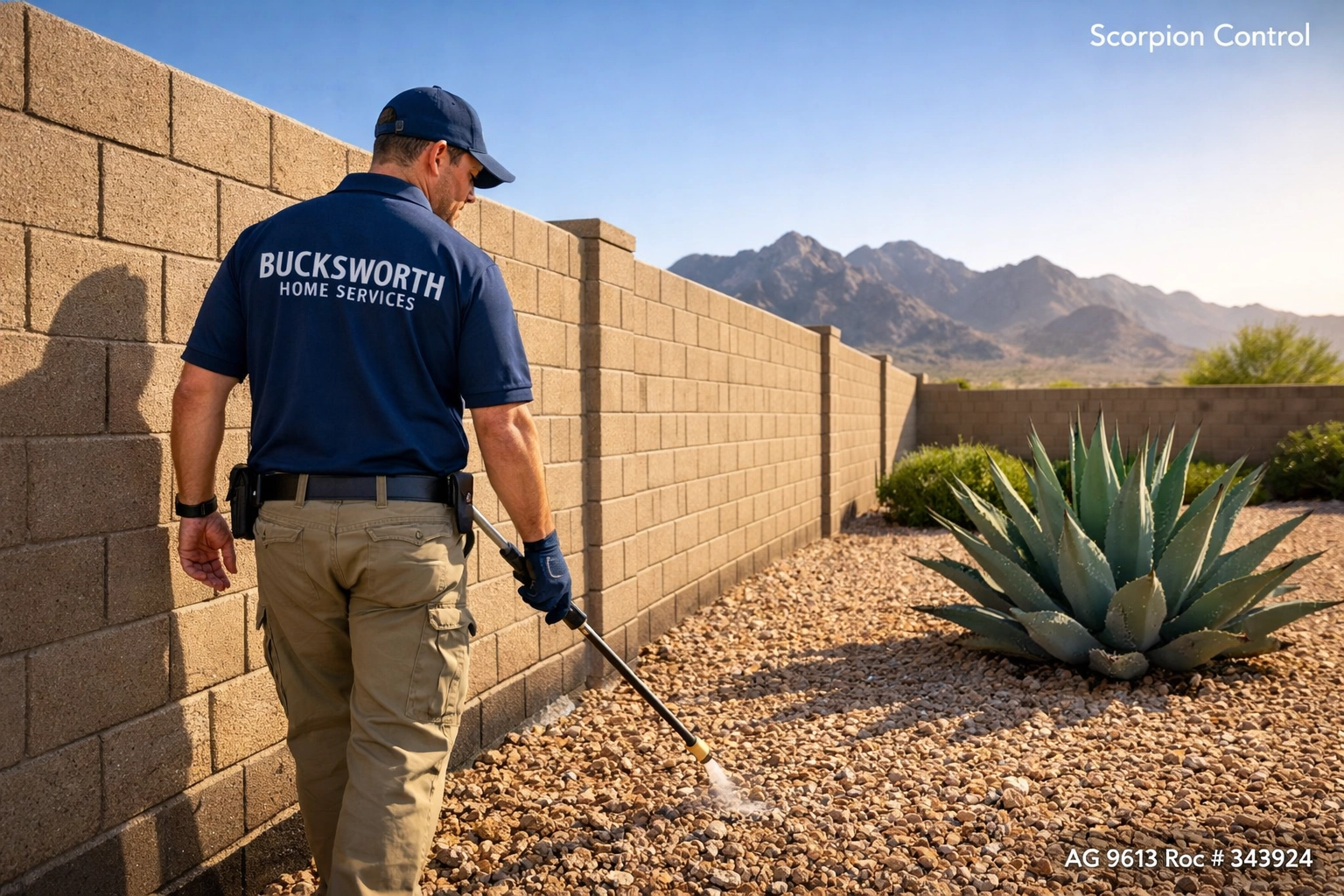 Bucksworth technician applying scorpion control treatment to a block wall in Goodyear, AZ near Estrella Mountains.