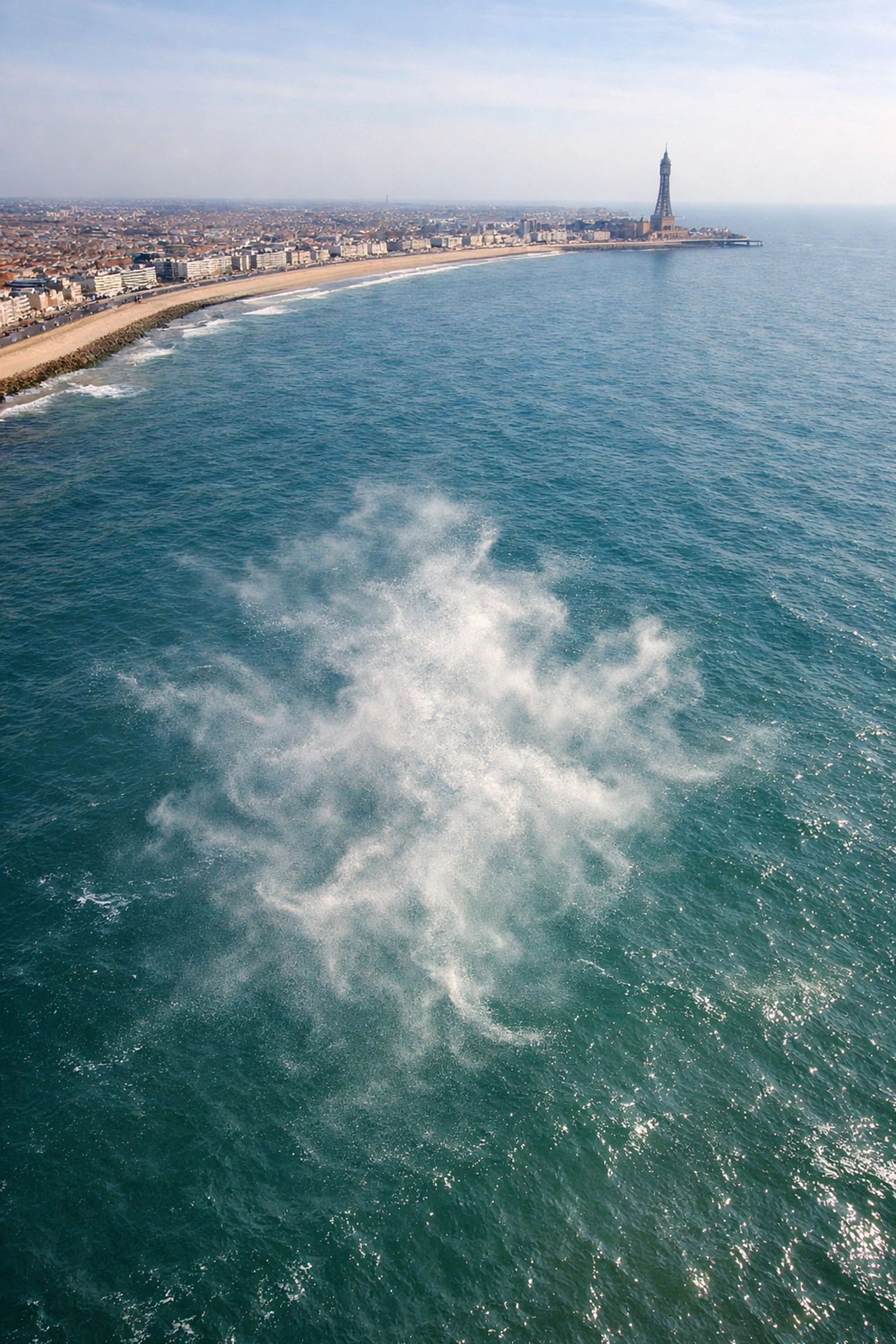 Aerial view of ashes dispersing over Irish Sea off Blackpool coast during memorial service