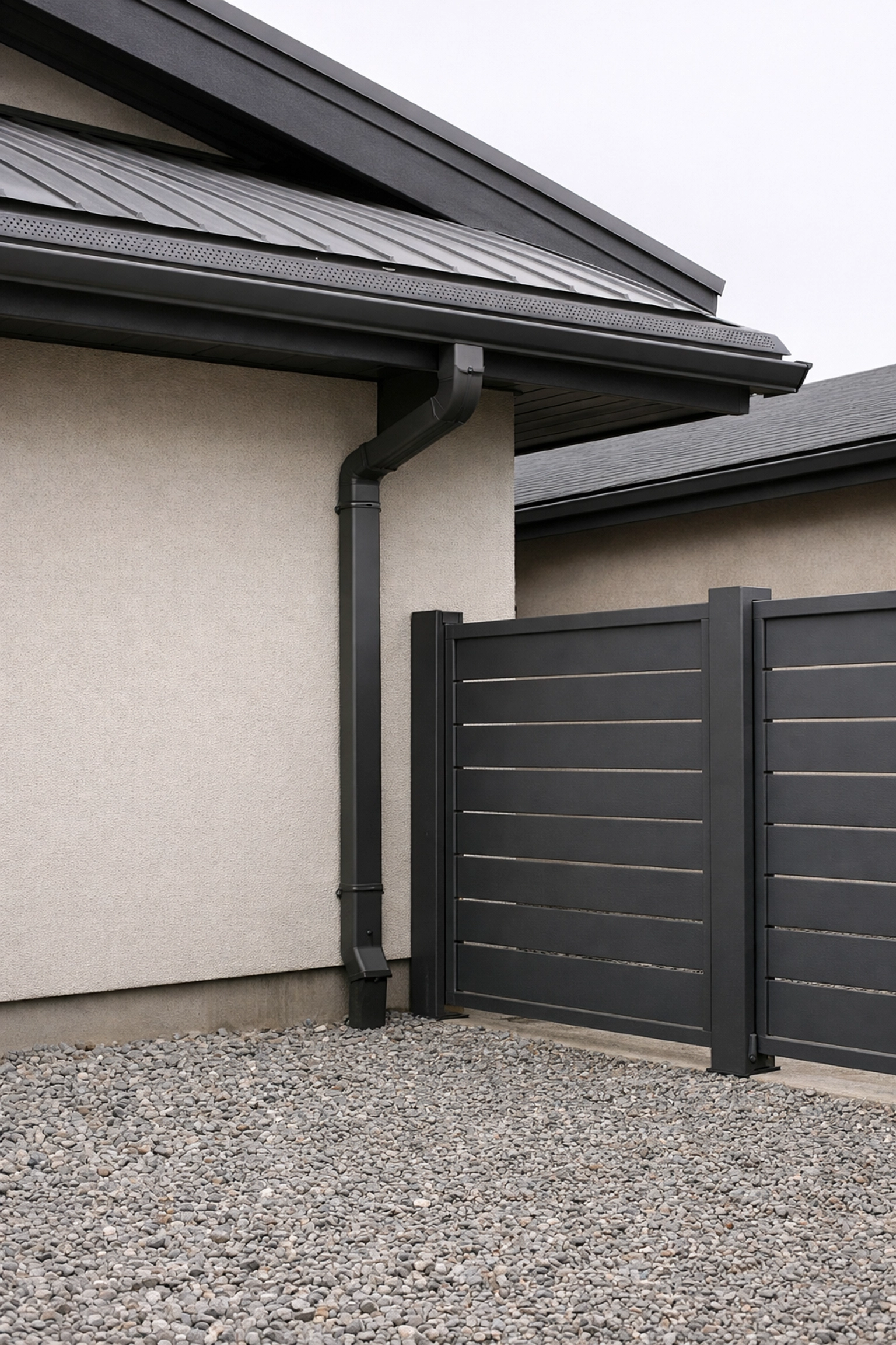 Home hardening upgrades featuring stucco walls, gutter guards, and Zone Zero landscaping