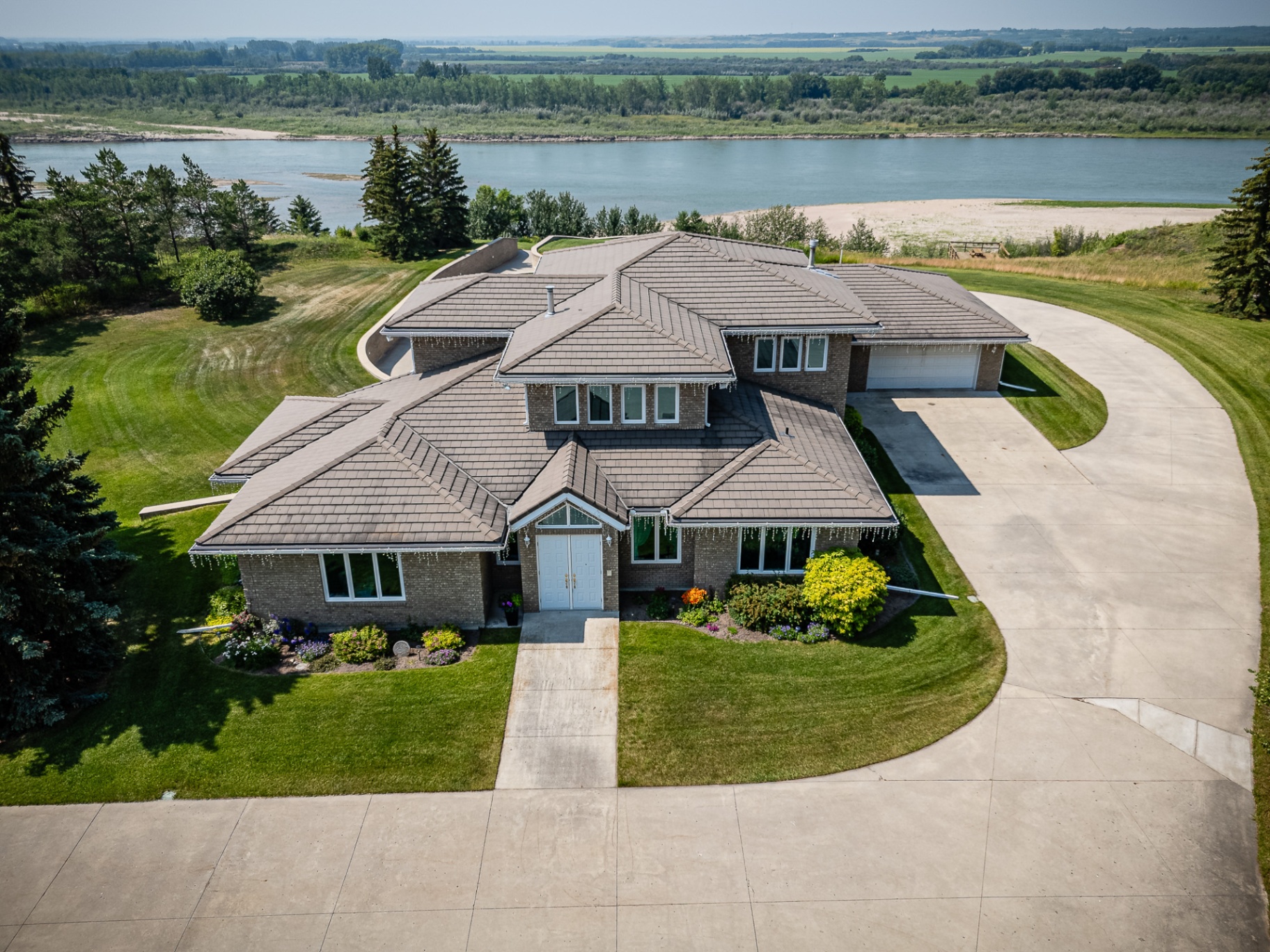 Aerial drone photo of executive-style home with river view