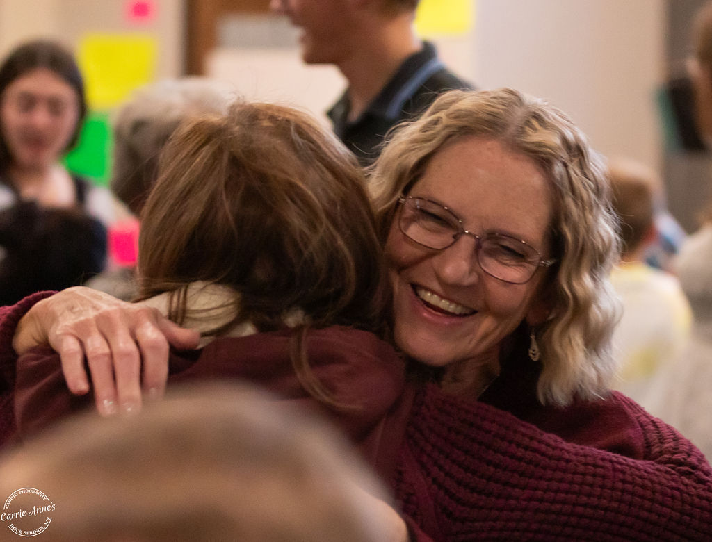 Two women warmly embracing at Green River Alliance Church, showing genuine connection