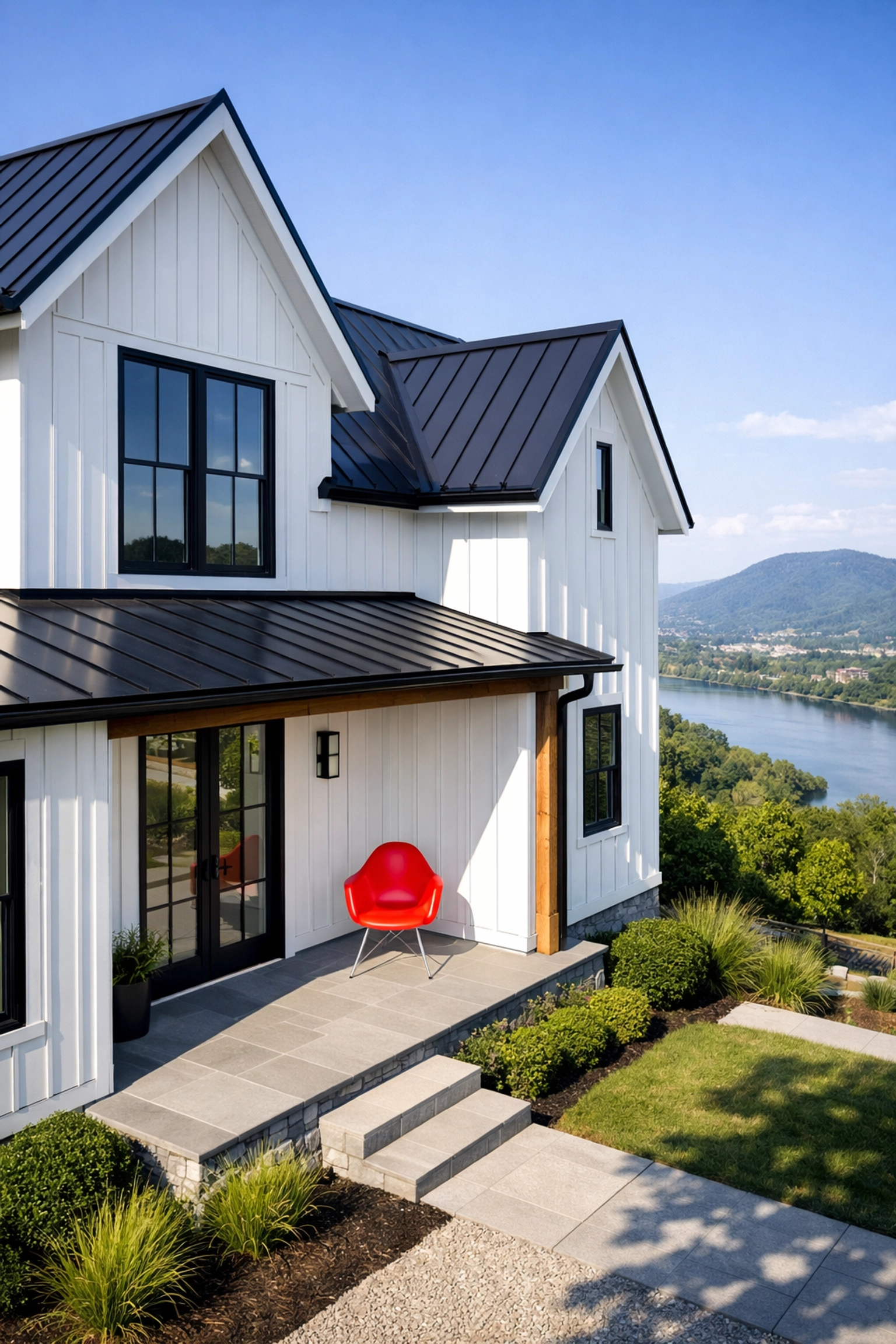 Modern farmhouse in Chattanooga featuring white vertical fiber cement siding and black window frames.