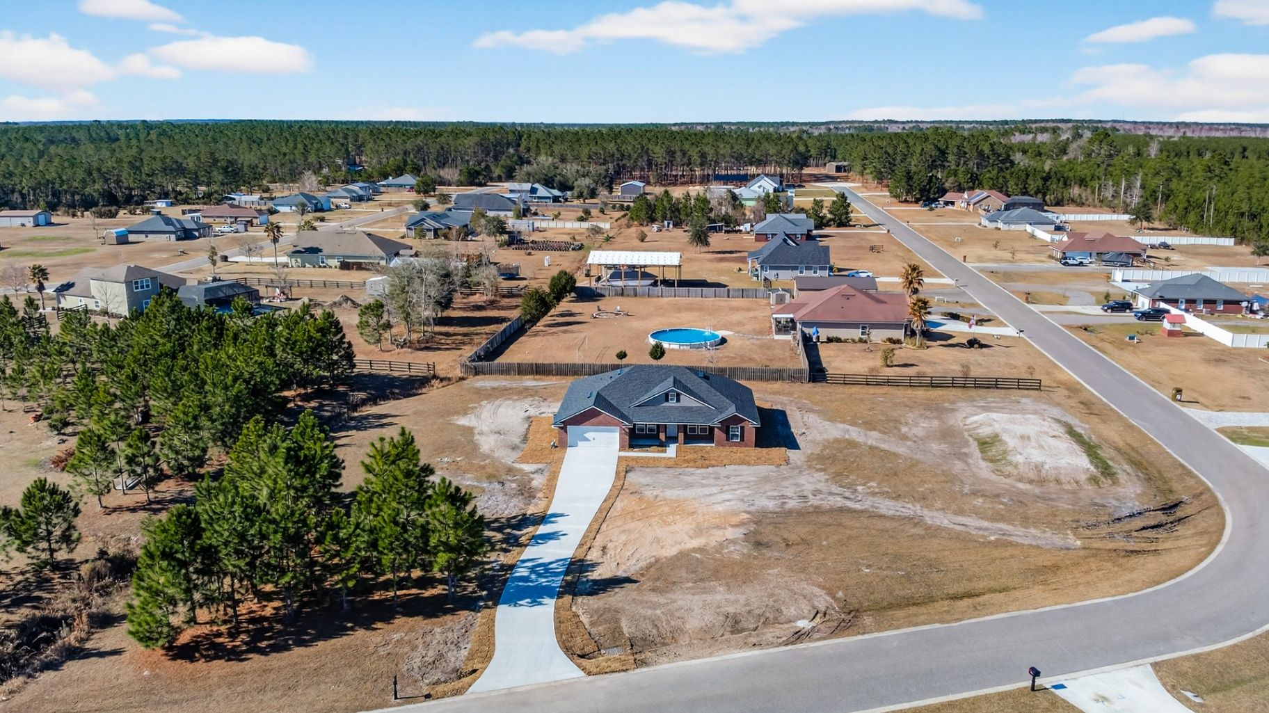 Before grass enhancement at 55225 Bartram Trail showing dormant brown lawn