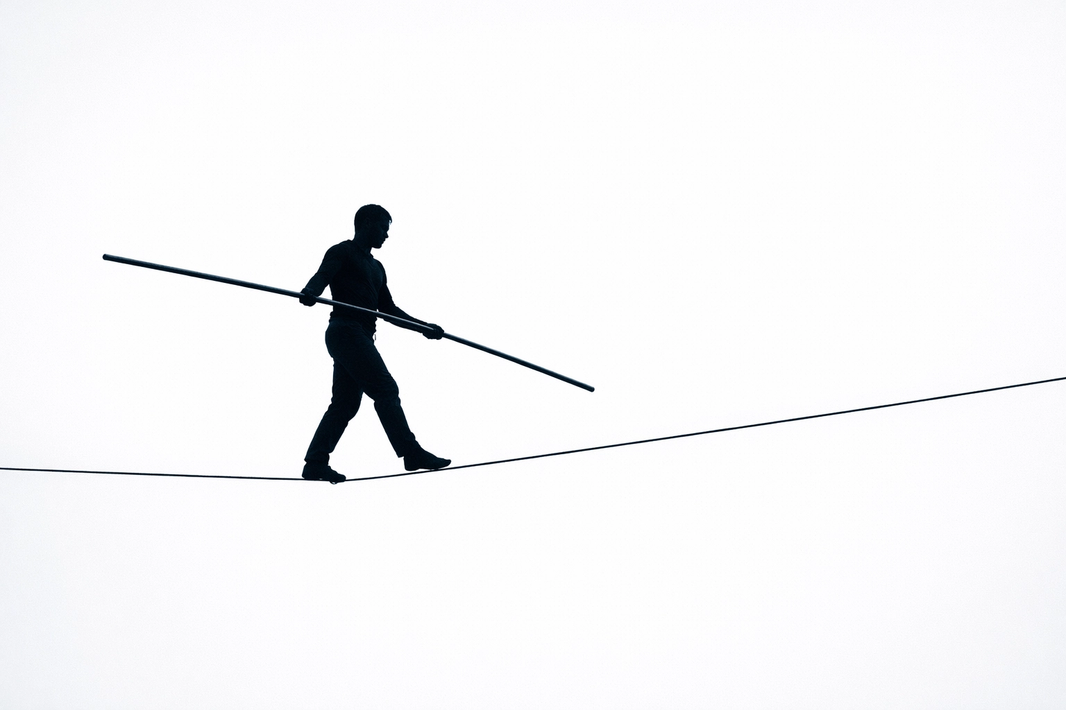 Person balancing on tightrope symbolizing delicate family dynamics affected by addiction