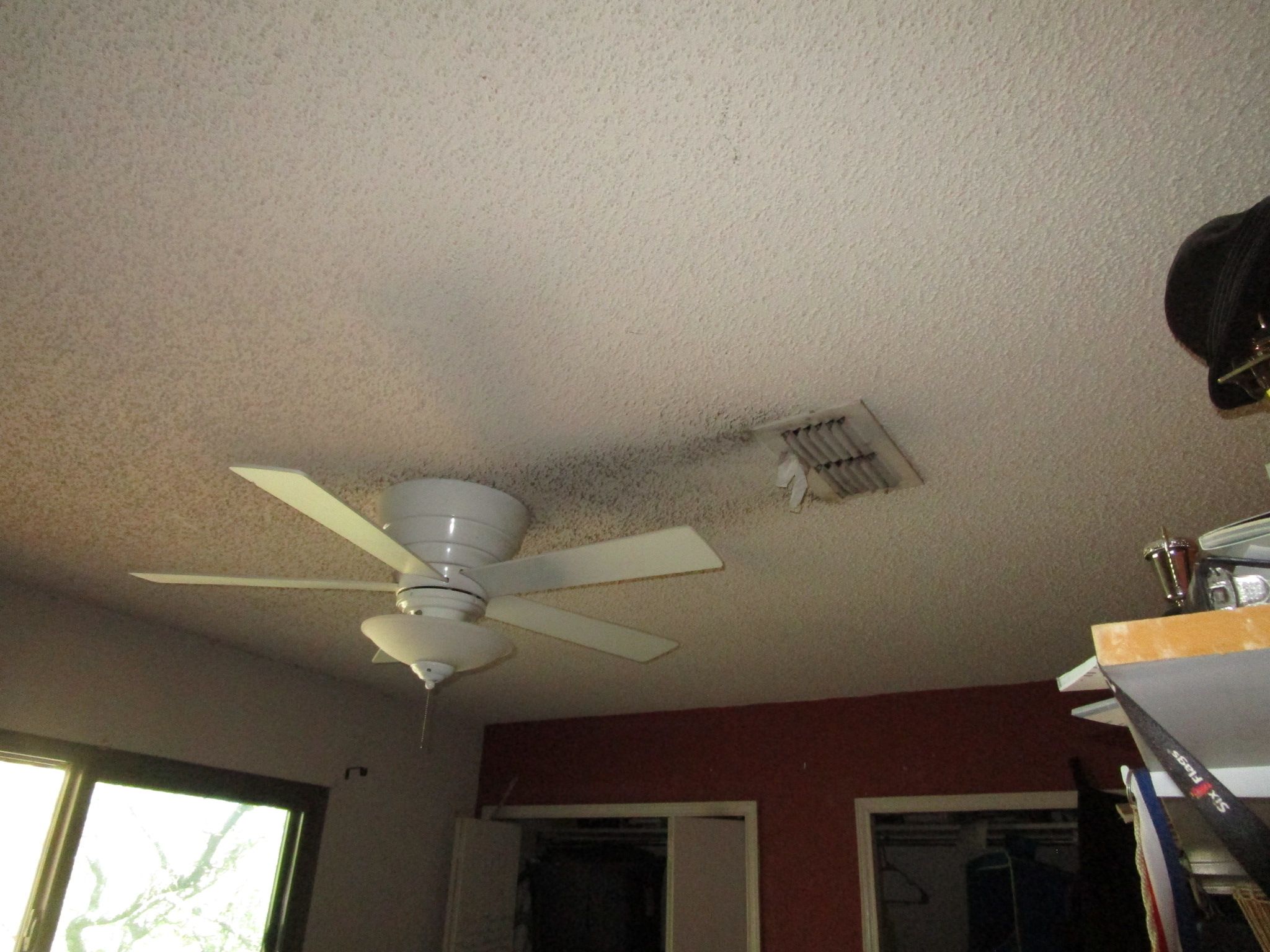Visible black mold staining around a bedroom HVAC vent