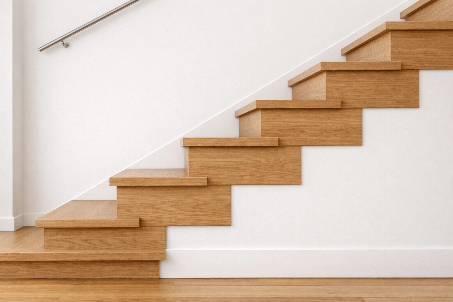 Profile view of wooden stairs showing safe, uniform tread depth and riser height in a well-lit home.
