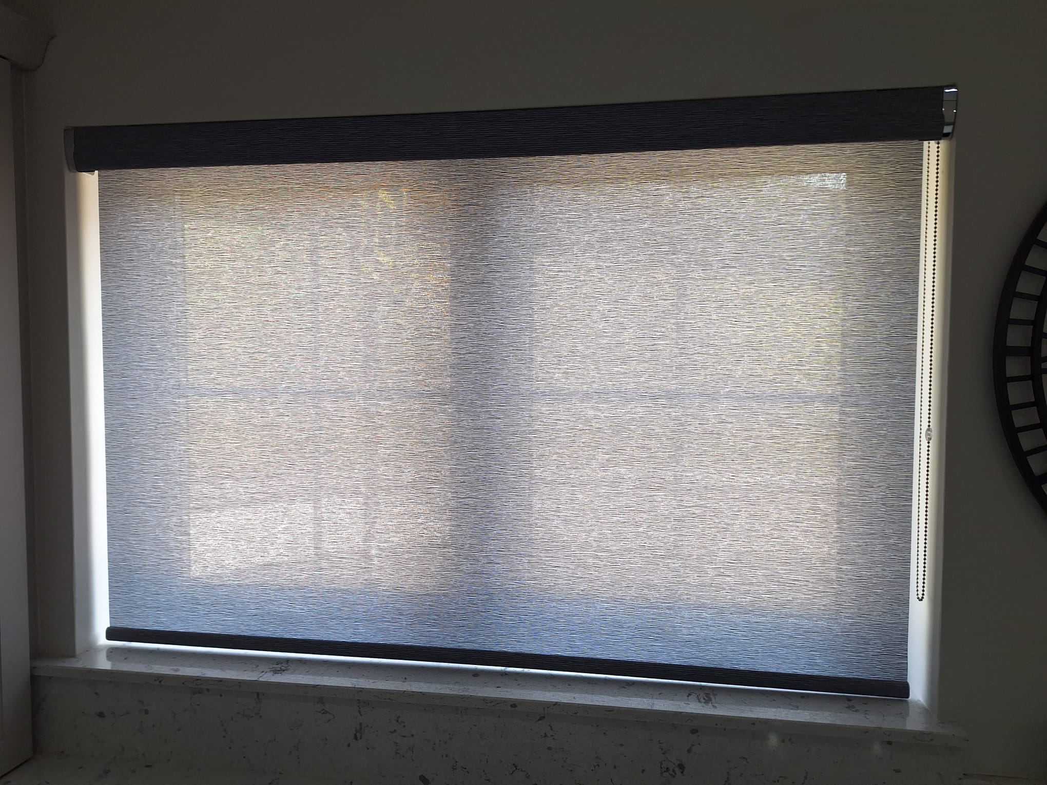 Light-filtering roller blind in a subtle textured fabric