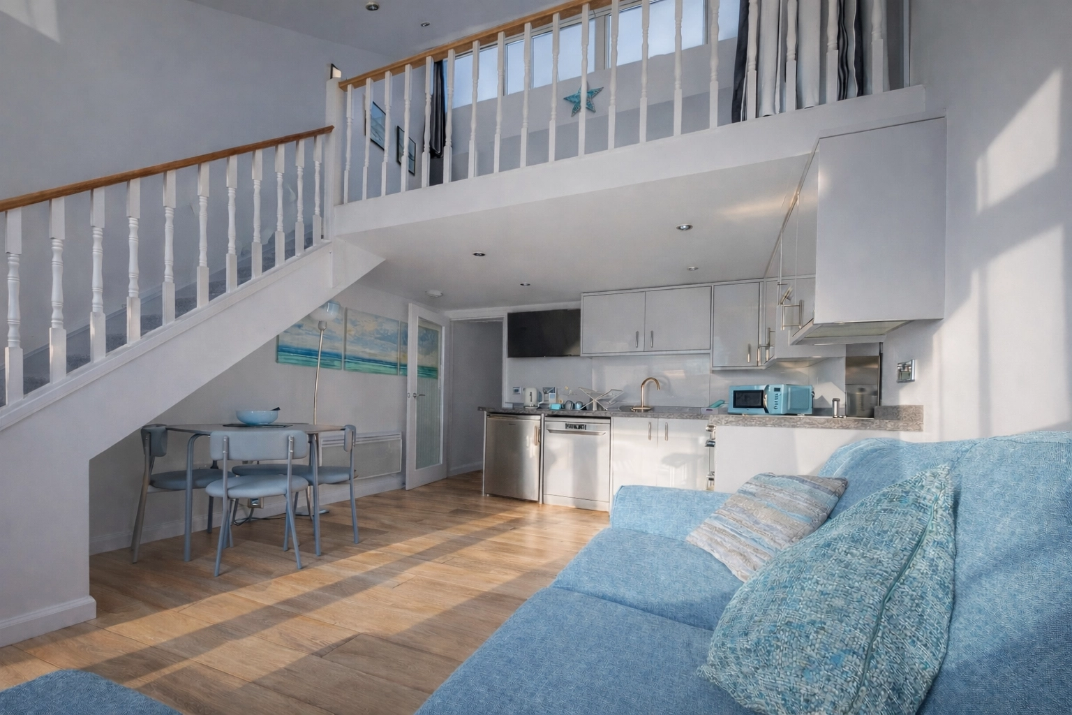 Beachfront view of Porthtowan beach with surfers from apartment balcony
