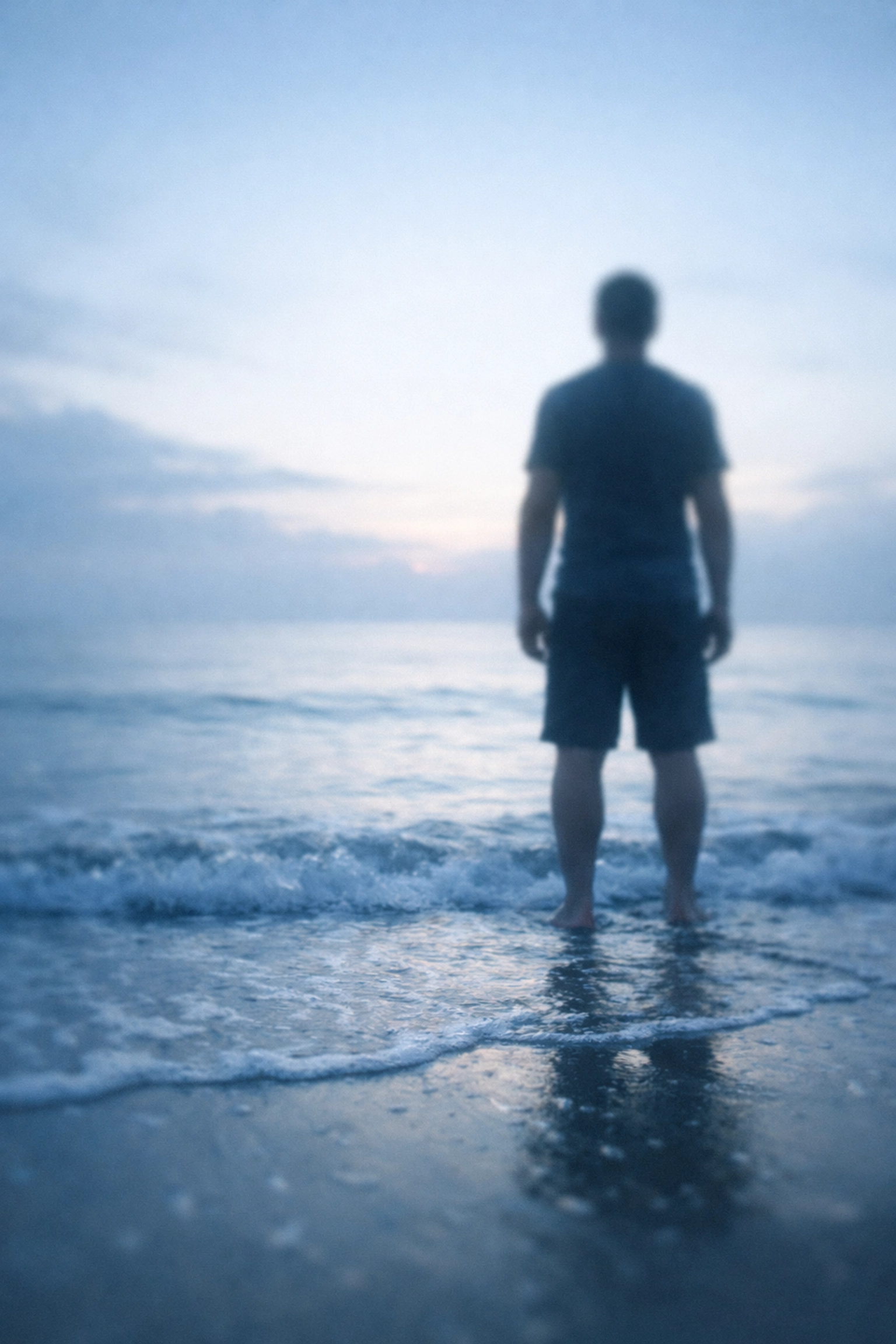 Person at ocean dawn representing emotional grounding and trauma recovery journey