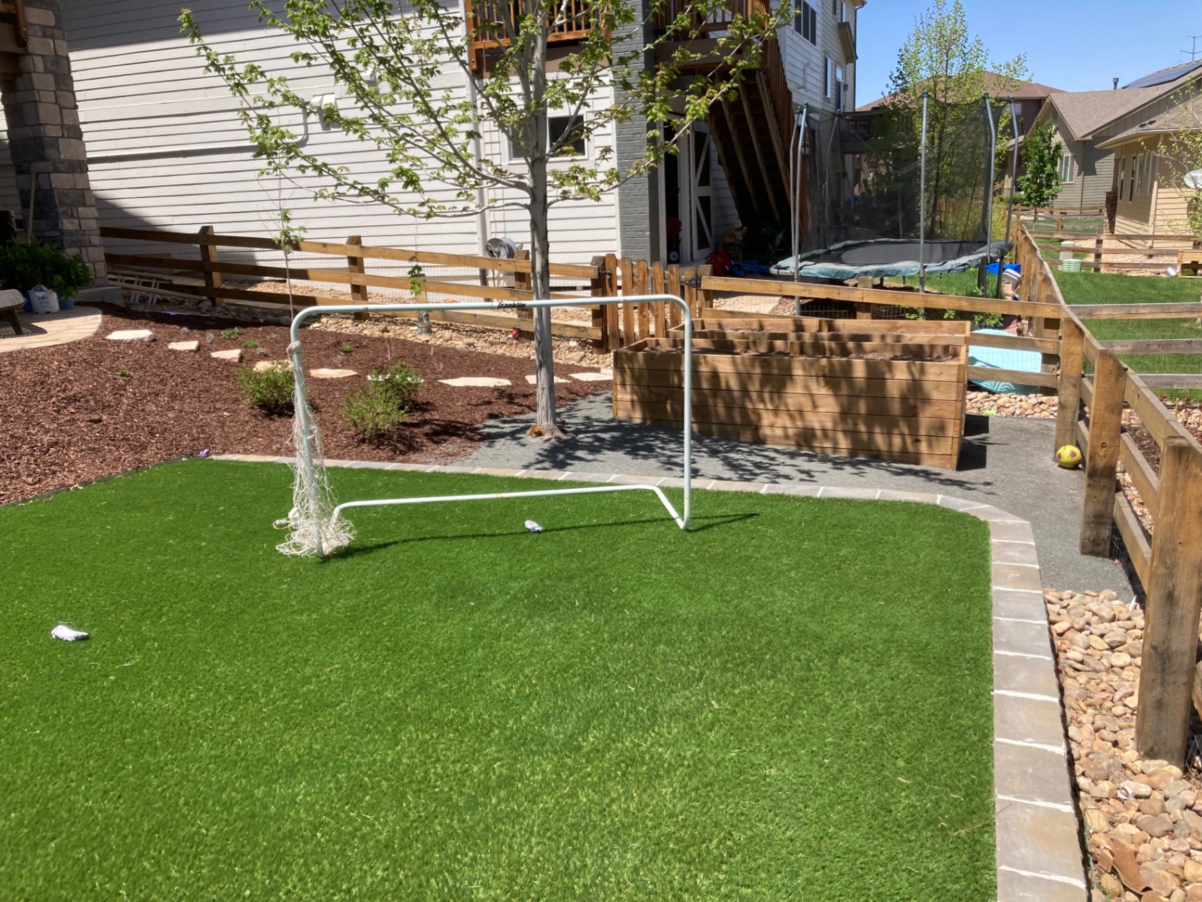 Artificial turf installation bordered with stone pavers