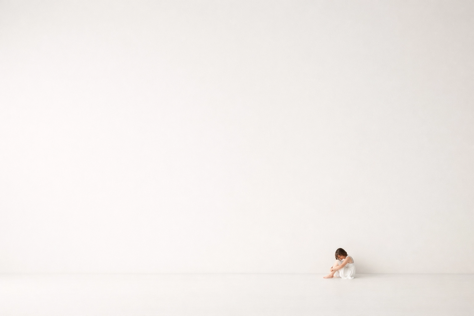 Minimalist fine art nude composition using negative space to highlight a delicate human figure and form.