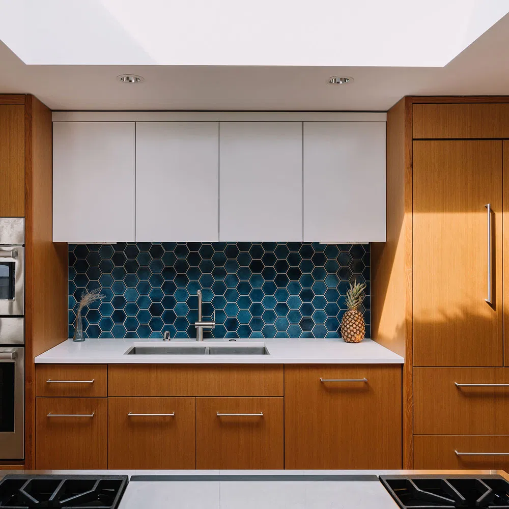 modern-kitchen-custom-wood-cabinetry-blue-tile.webp