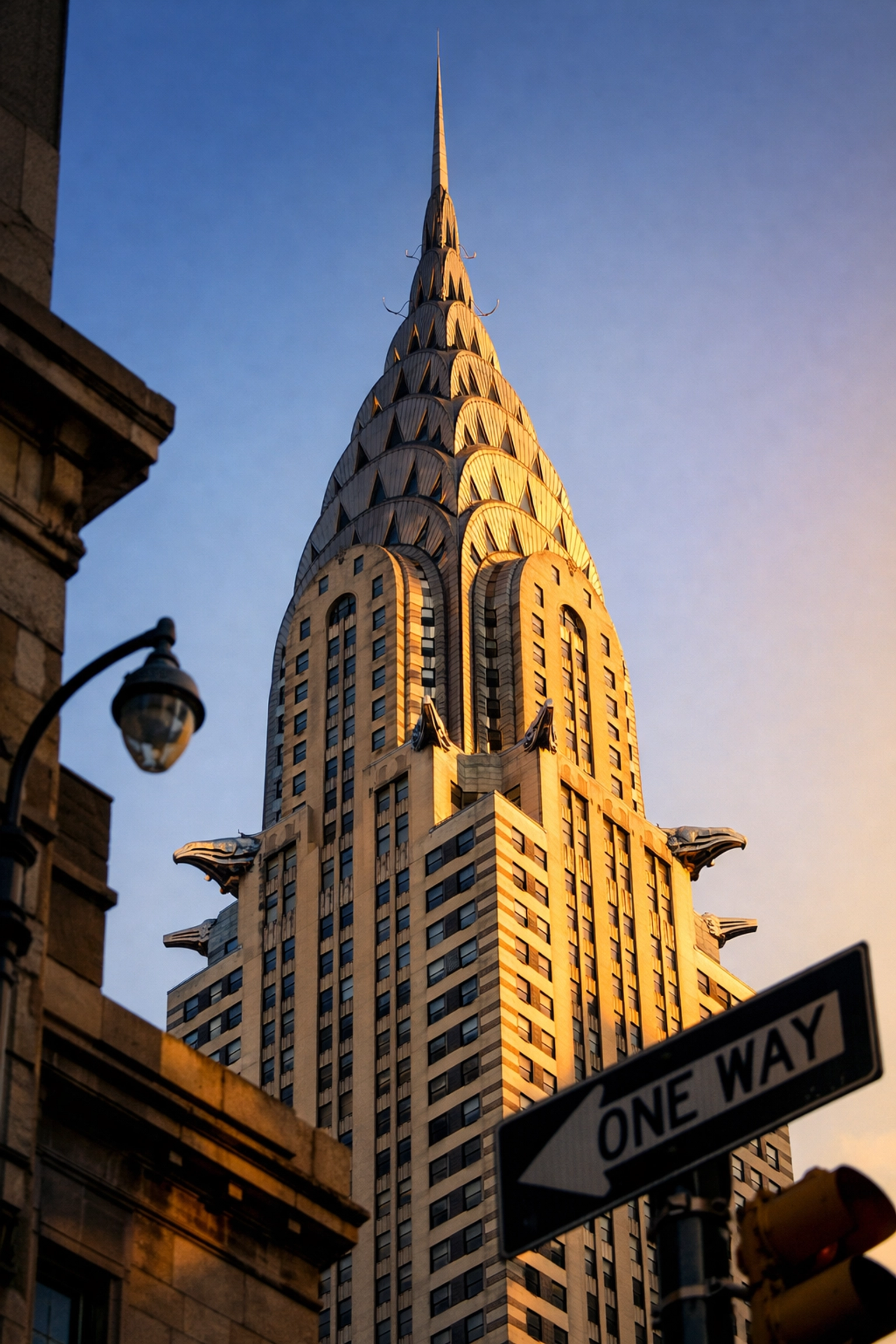 Fine-art photo of the Chrysler Building's Art Deco spire in Midtown Manhattan during golden hour.