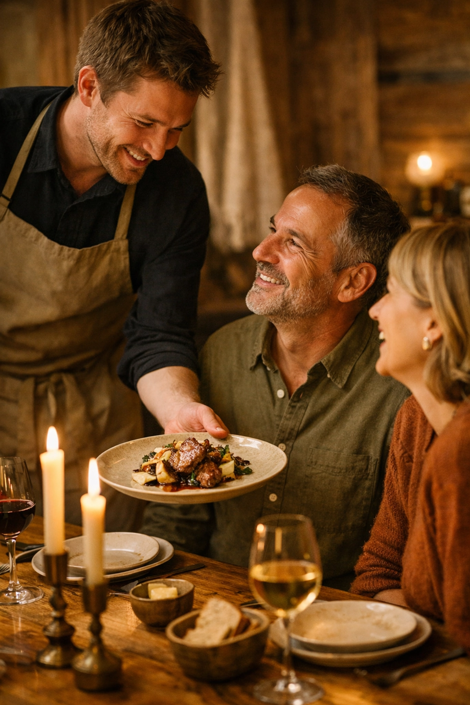 Server presenting plated dish to engaged diners at candlelit table in intimate restaurant setting
