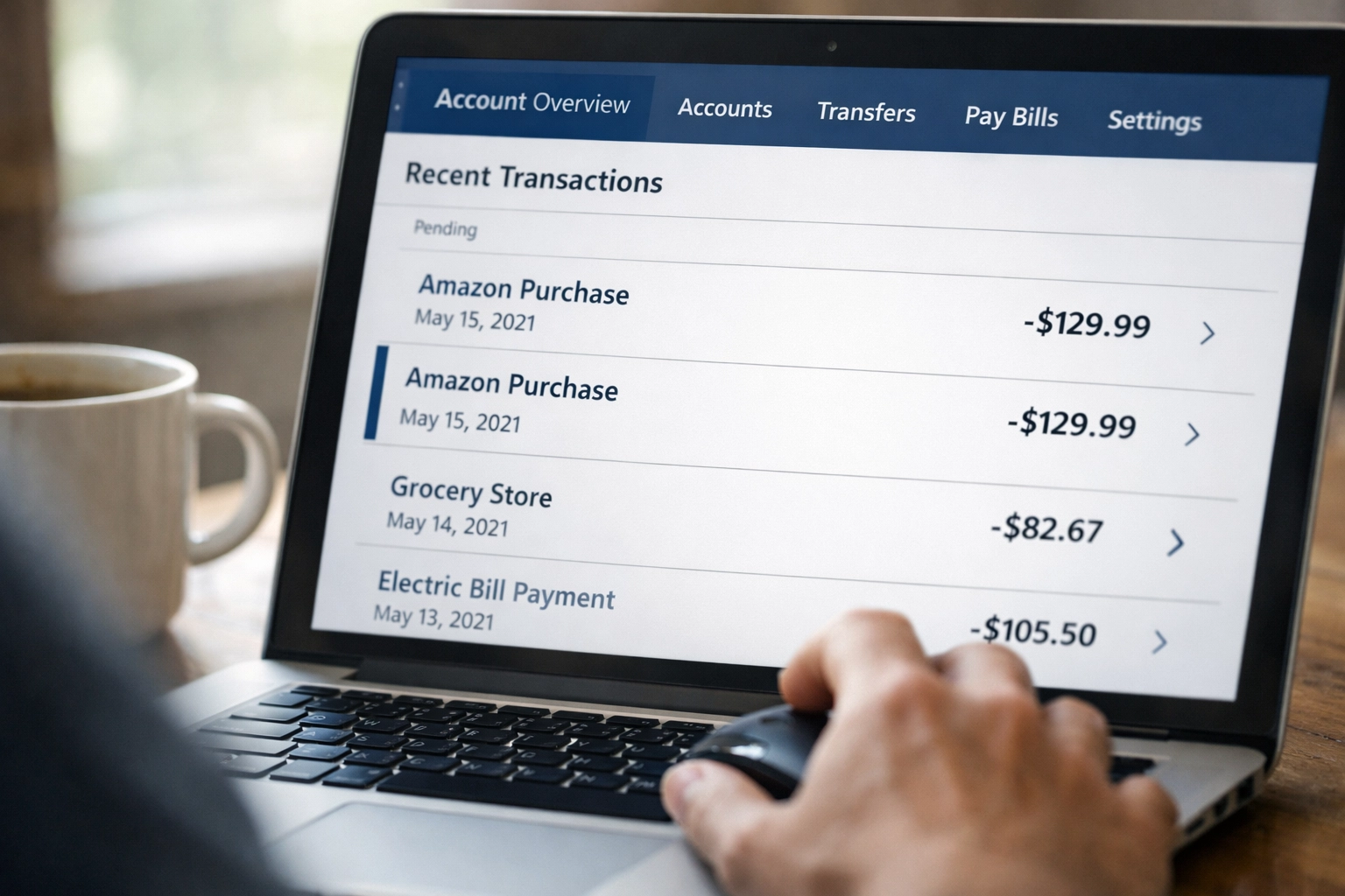 Small business owner reviewing QuickBooks Online bank feed transactions on laptop