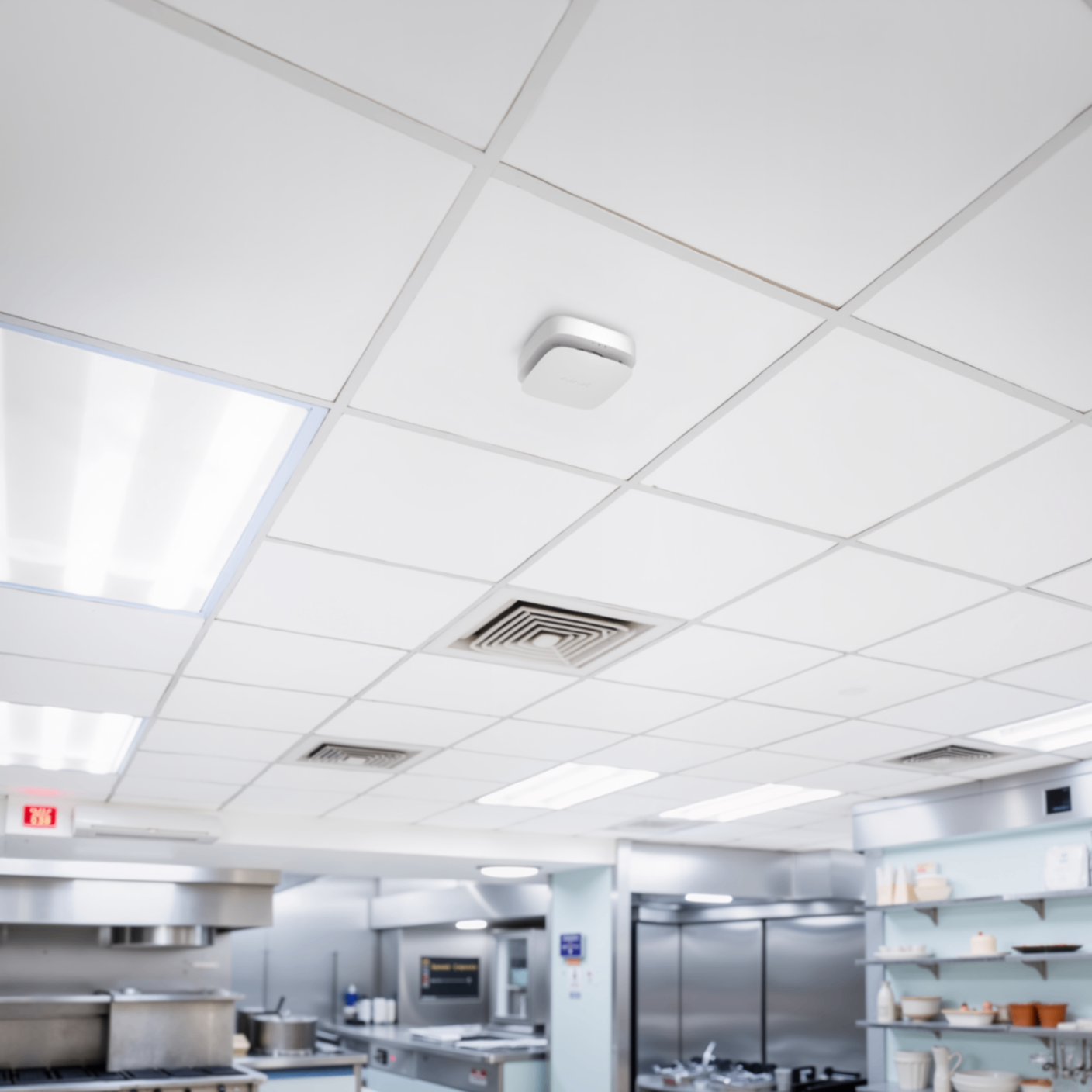 Ceiling-mounted fire alarm detector in commercial kitchen