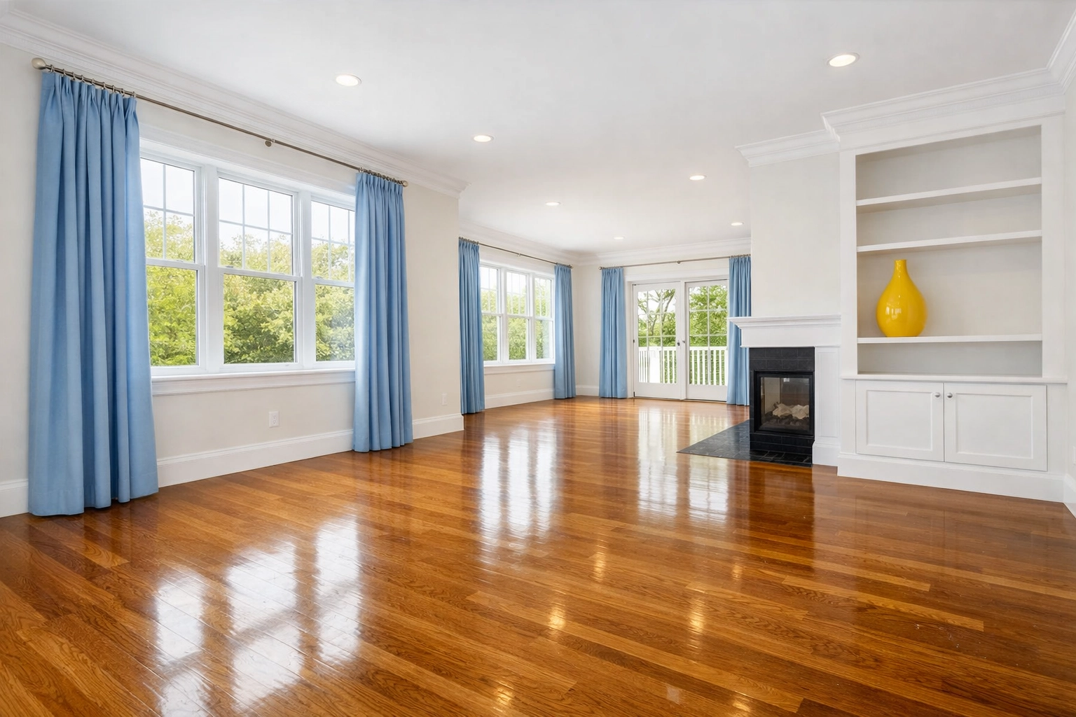 Pristine Massachusetts living room with polished hardwood floors after a professional deep cleaning.