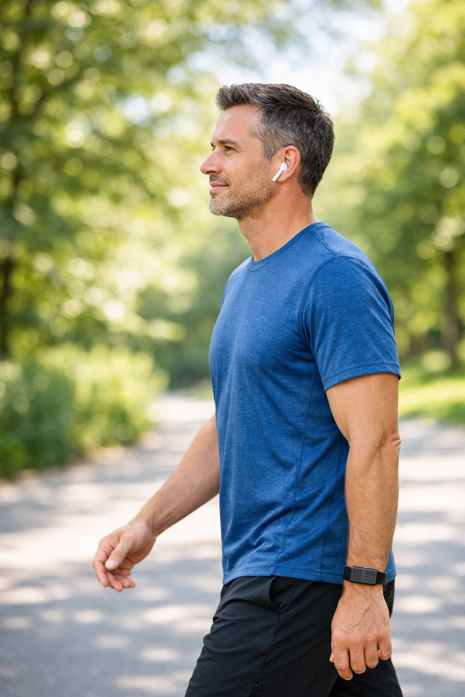 Man walking in a park, showing a consistent healthy lifestyle and freedom from restrictive dieting.