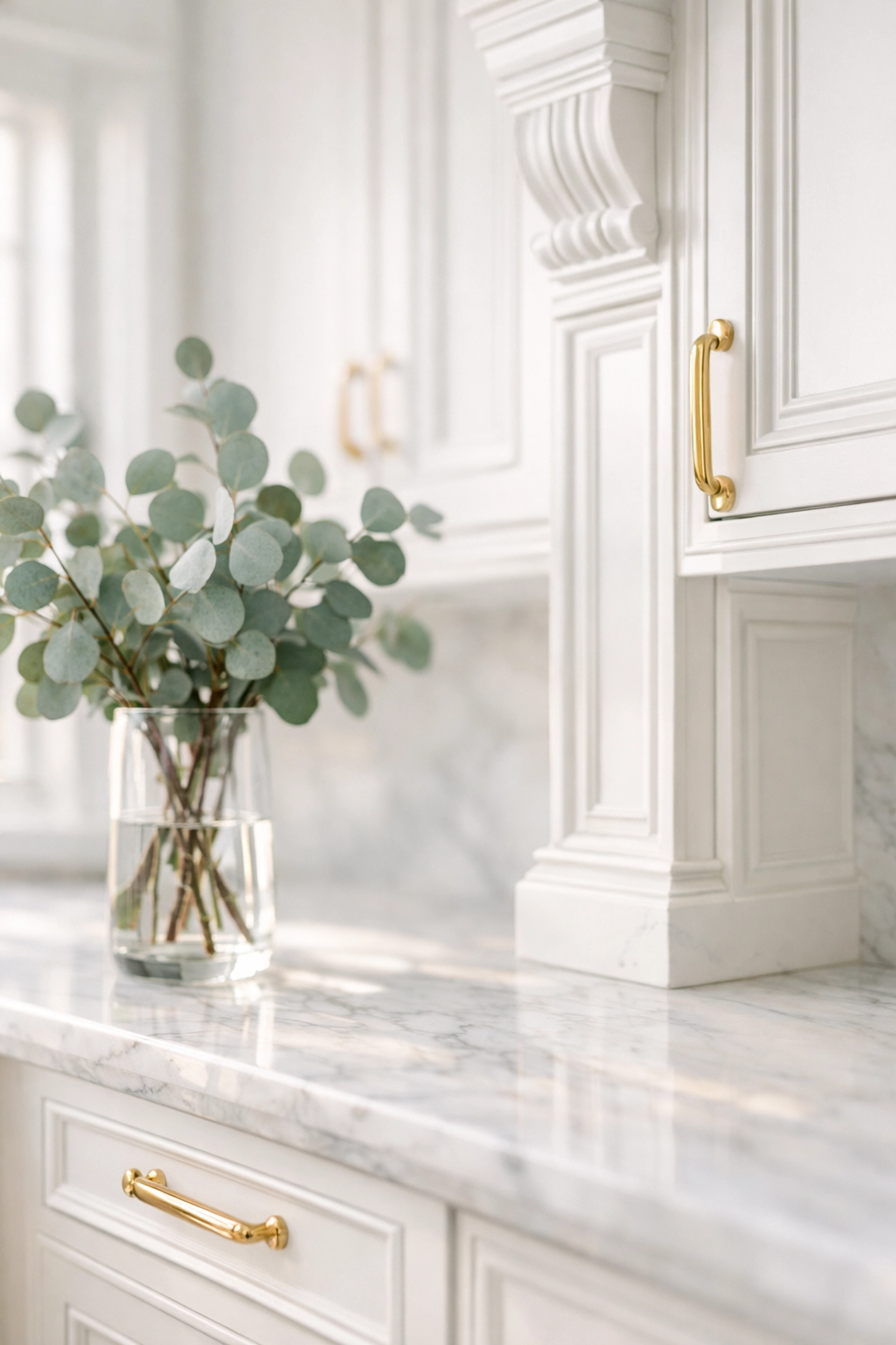 Custom white kitchen cabinetry detail showing professional craftsmanship and marble countertops