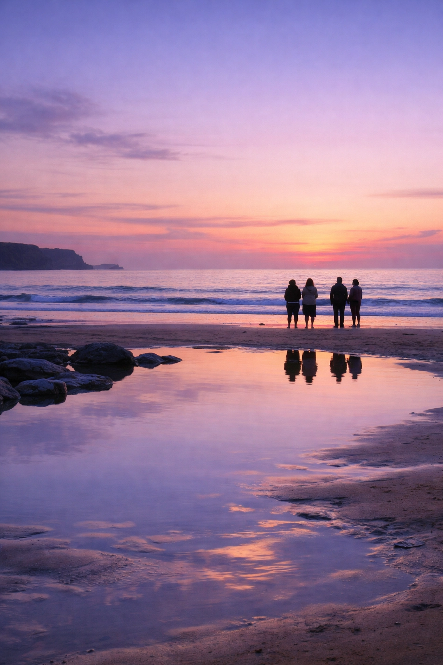 Families gather for a peaceful UK beach ashes scattering ceremony on a serene coast at sunset.
