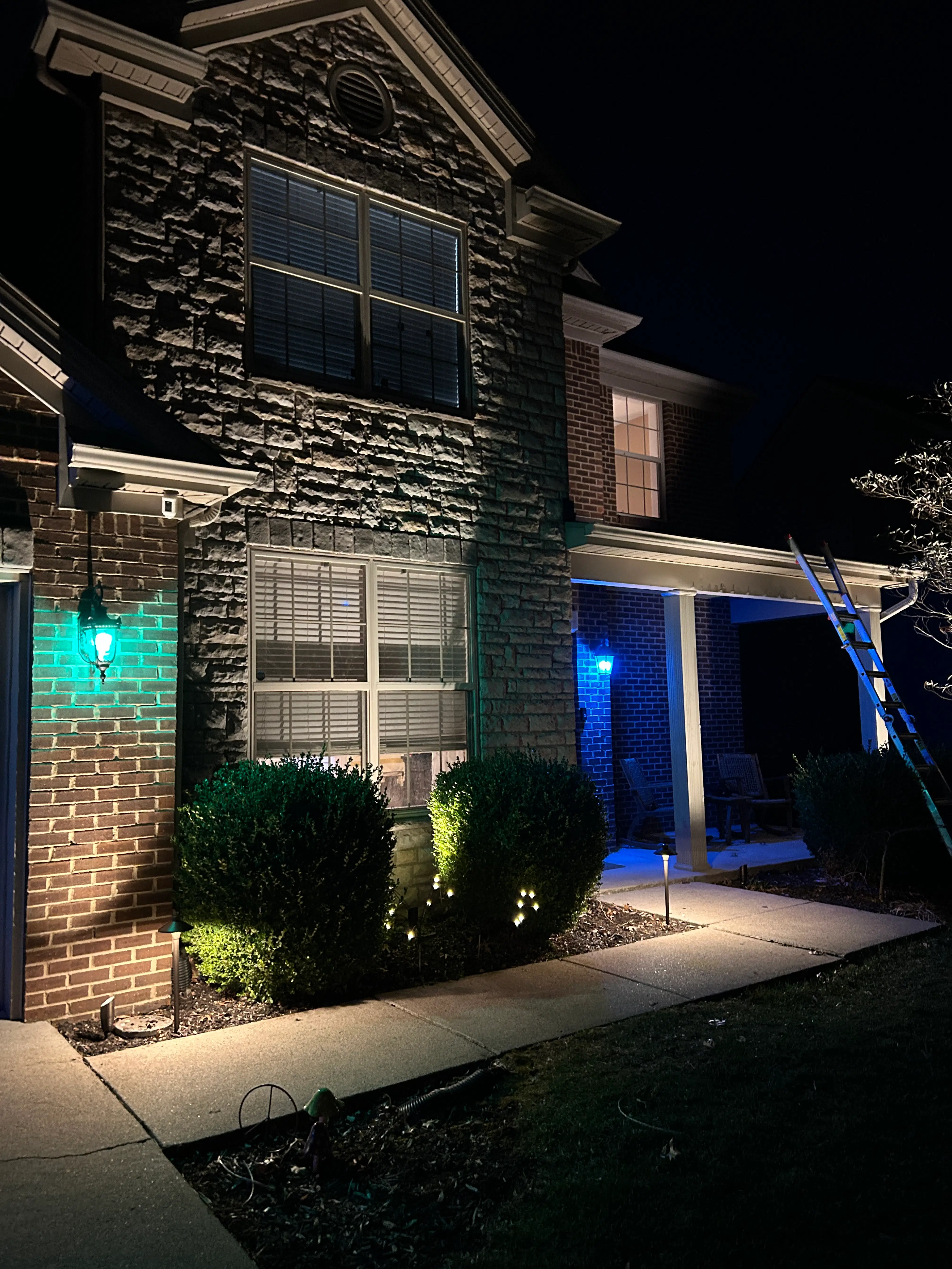 Permanent Lighting Secrets Revealed: What Landscape Lighting Experts in Nicholasville Won't Tell You Custom pathway and landscape lighting featuring accent uplighting on a stone façade and app-controlled blue feature lights