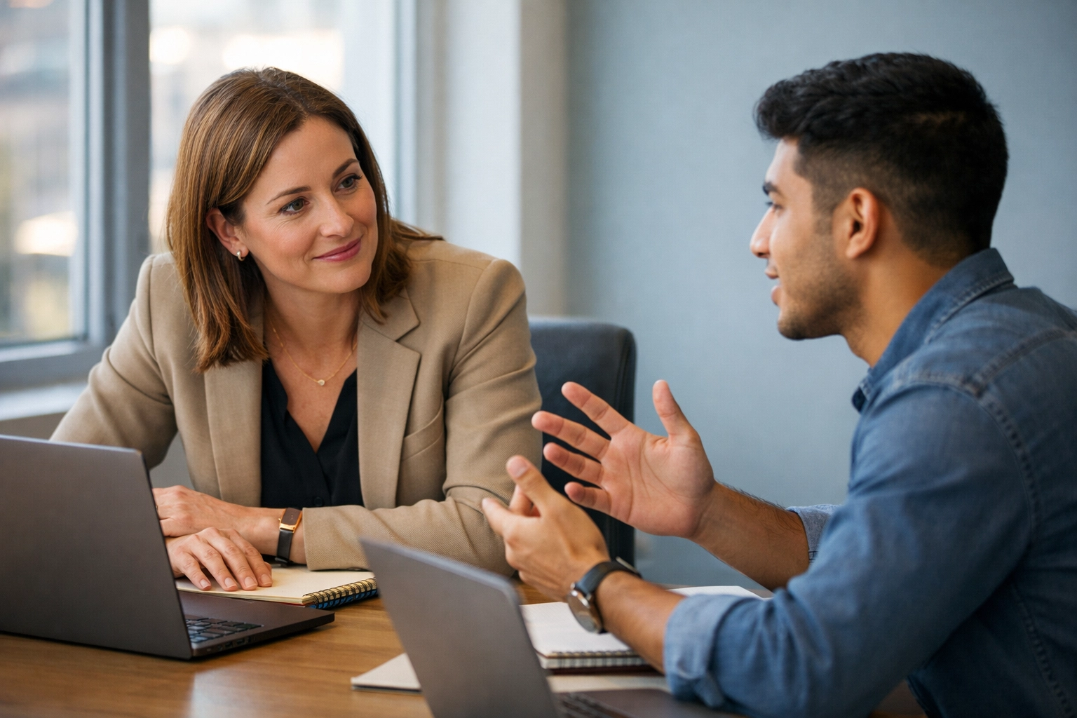 New manager conducting one-on-one meeting with team member during first 90 days