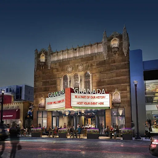 The historic Granada Theater building at dusk with marquee lights illuminated