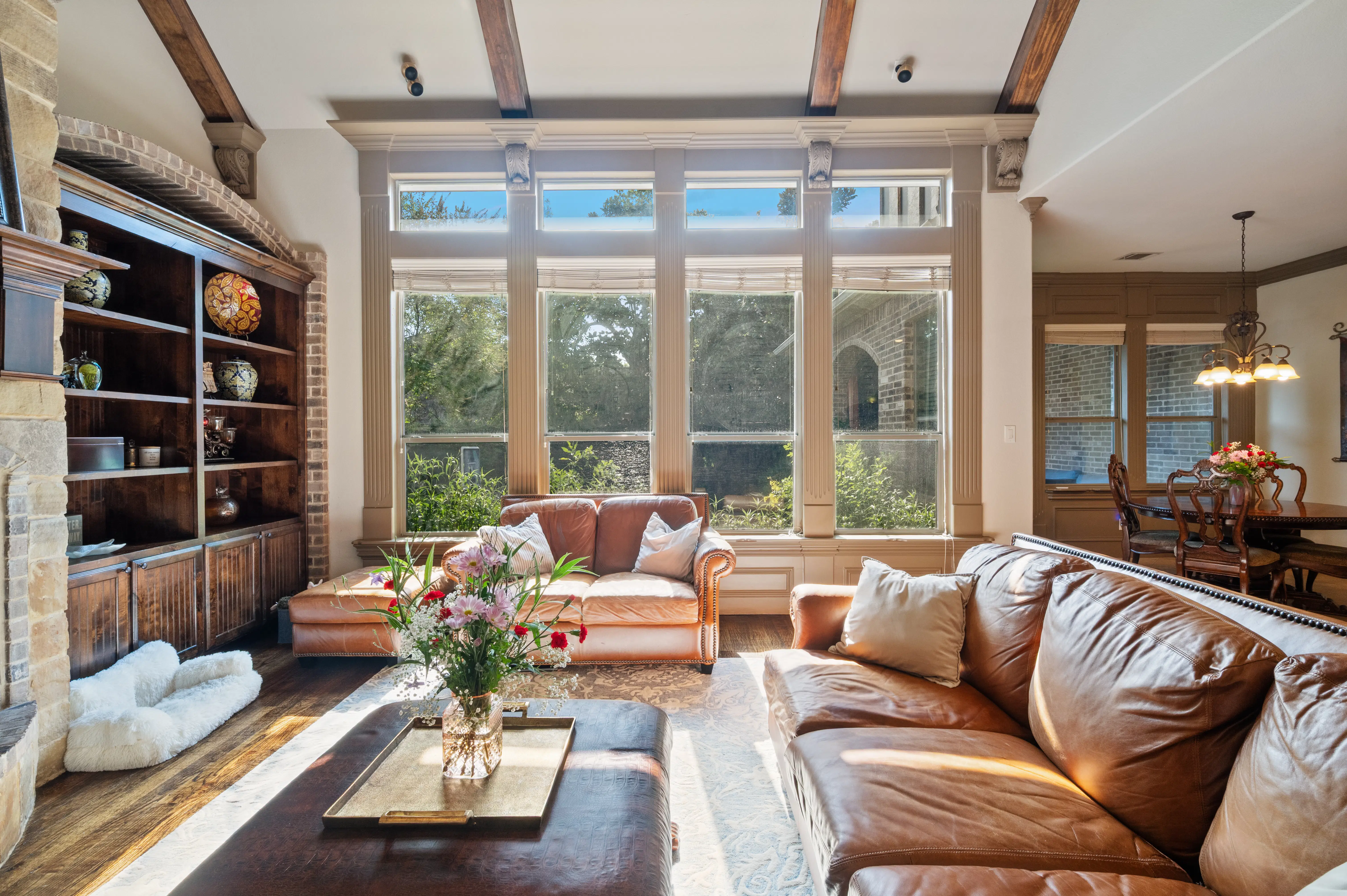 Bright living area with wood beams and leather sofas