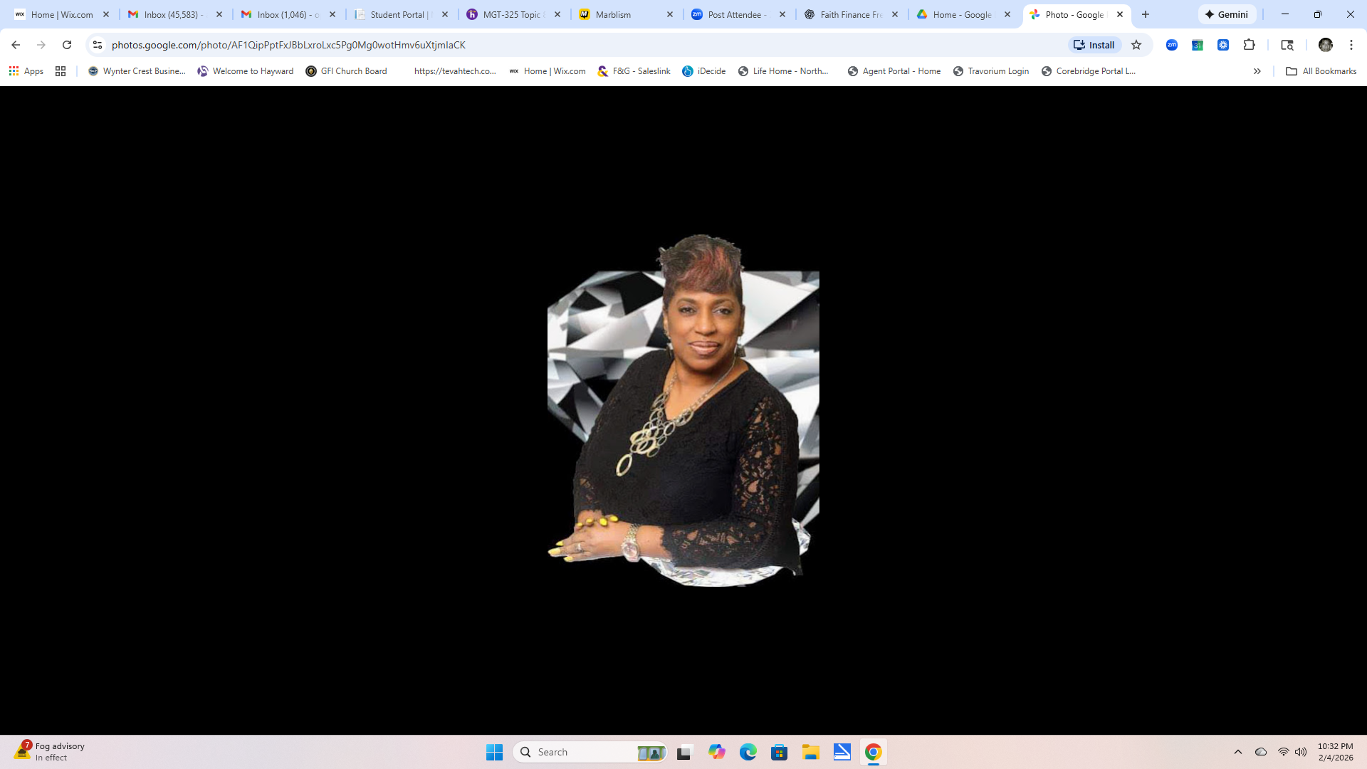 A professionally dressed woman seated in front of a diamond graphic