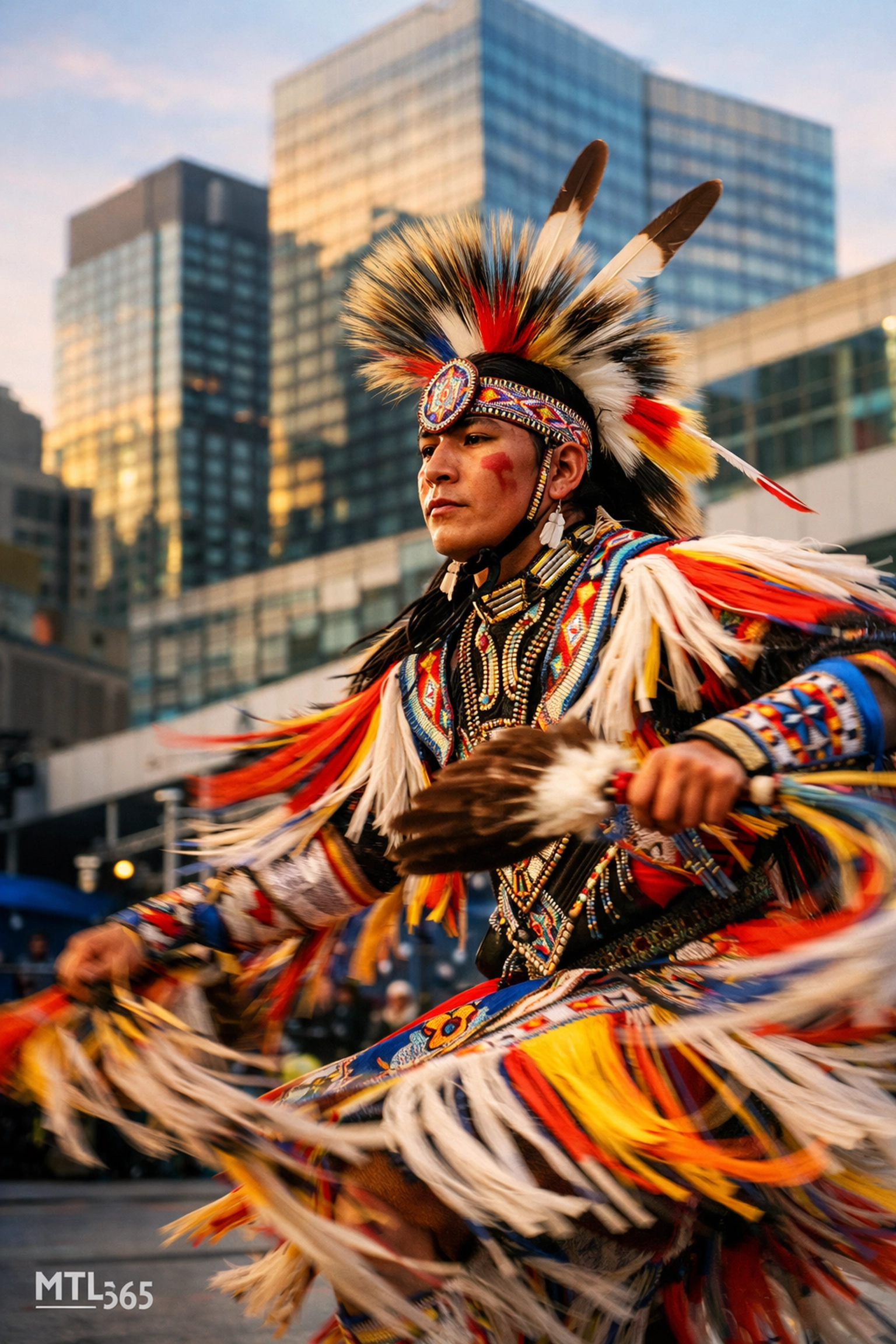 Indigenous dancer in traditional regalia performing at the International First Peoples' Festival in Montreal.